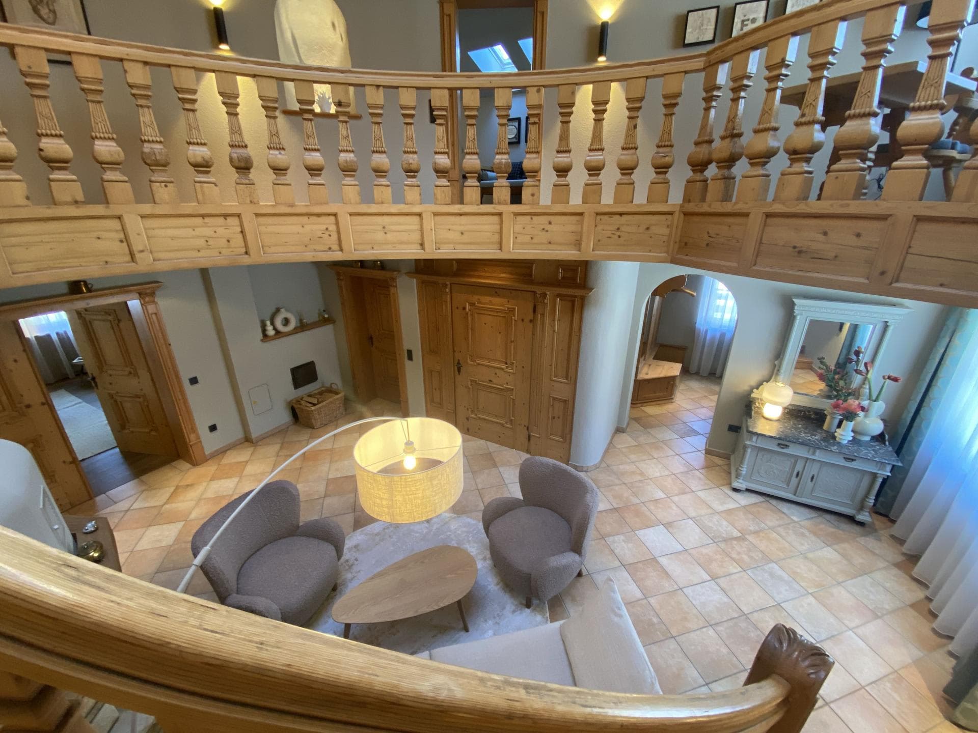 Mezzanine overlook of central seating area with carved wood railings
