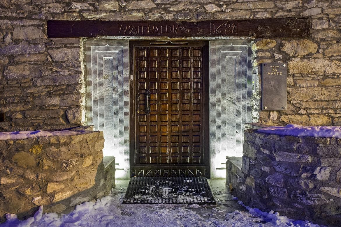 Stone entrance with 1682 date inscription and backlit side panels