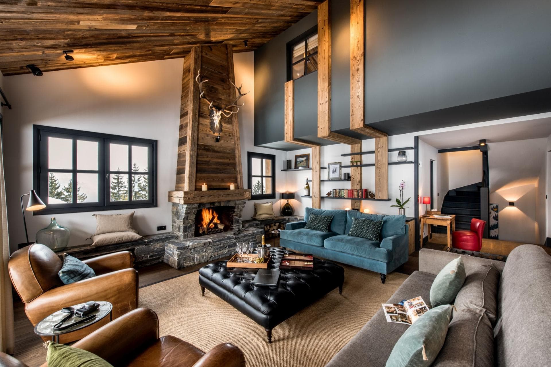 Living area with wood-burning fireplace and vaulted reclaimed timber ceilings