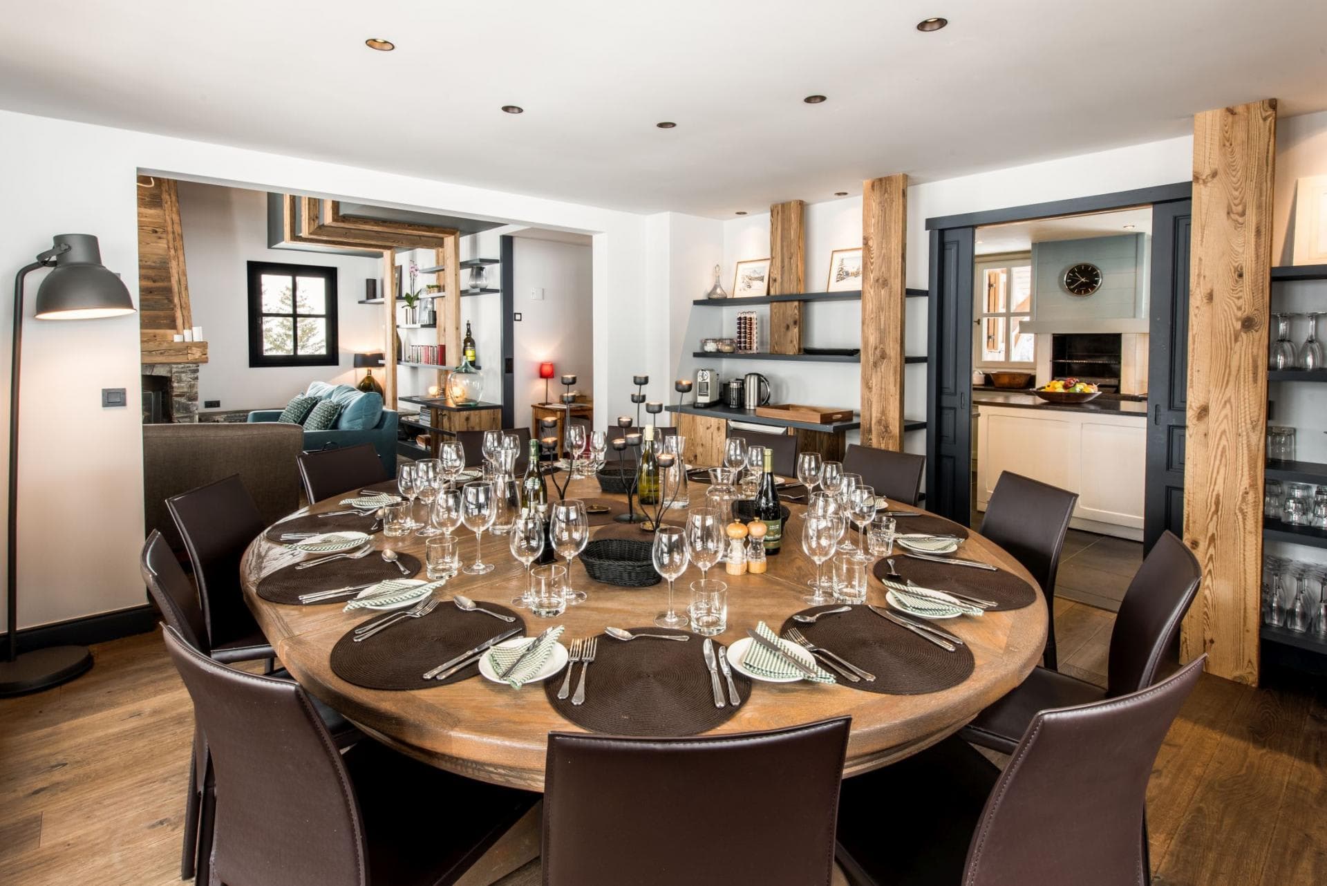 Round dining table with seating for 12; adjacent to kitchen