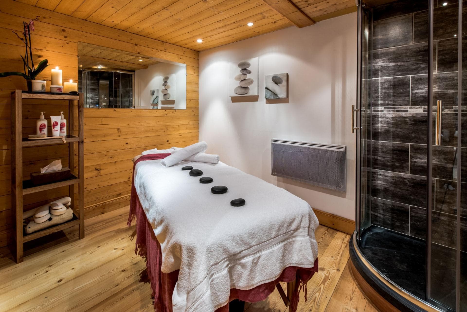 Private massage room with walk-in shower and wood-paneled walls