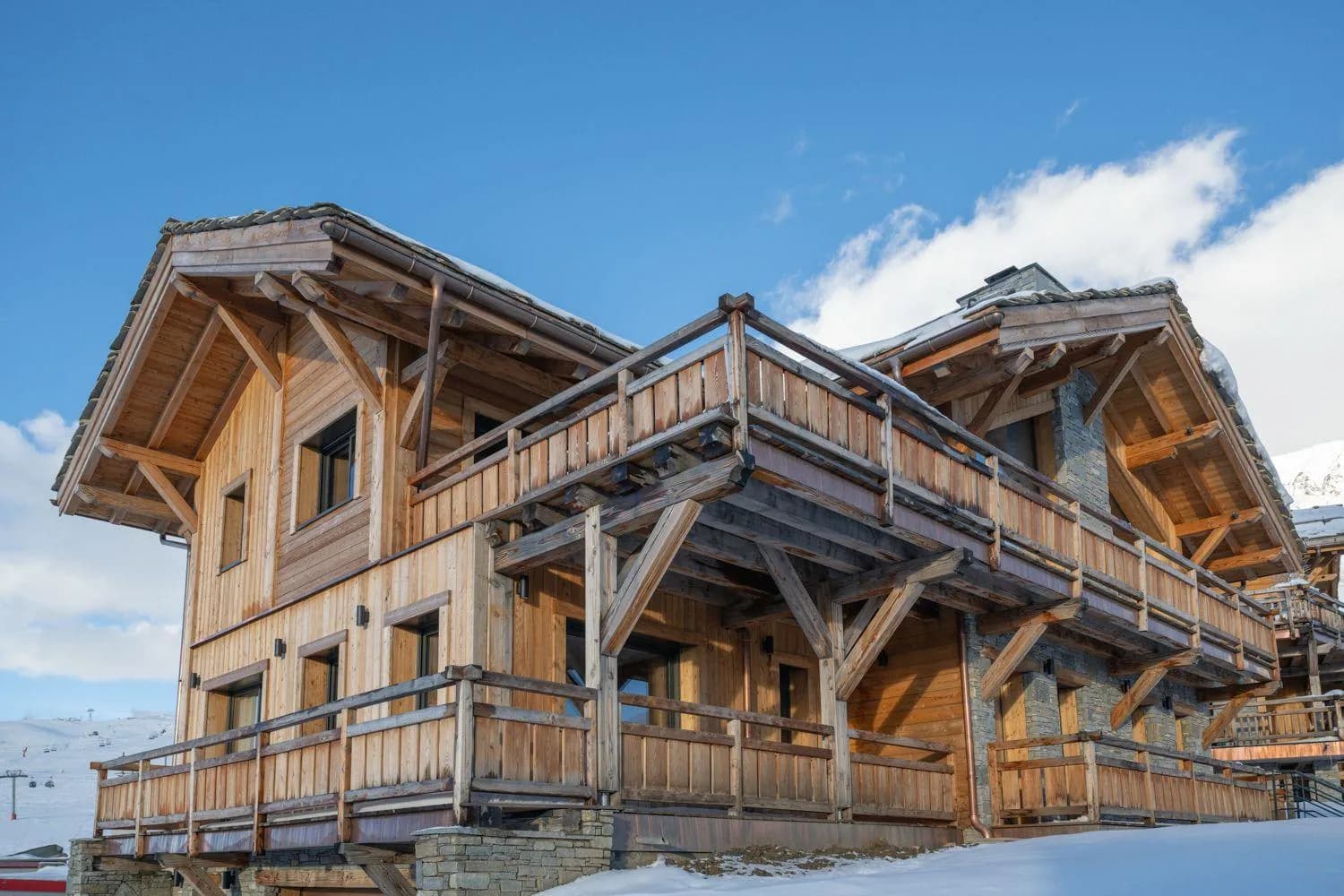 Chalet exterior with timber balconies and stone masonry