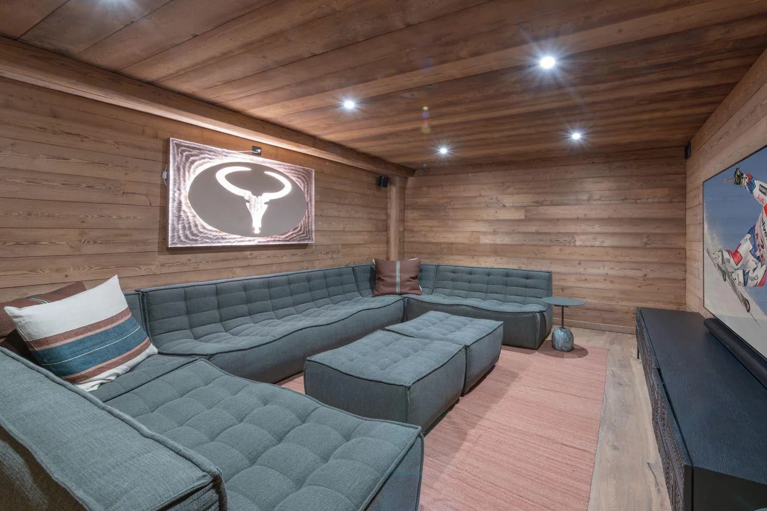 Cinema lounge with sectional seating and timber wall panelling