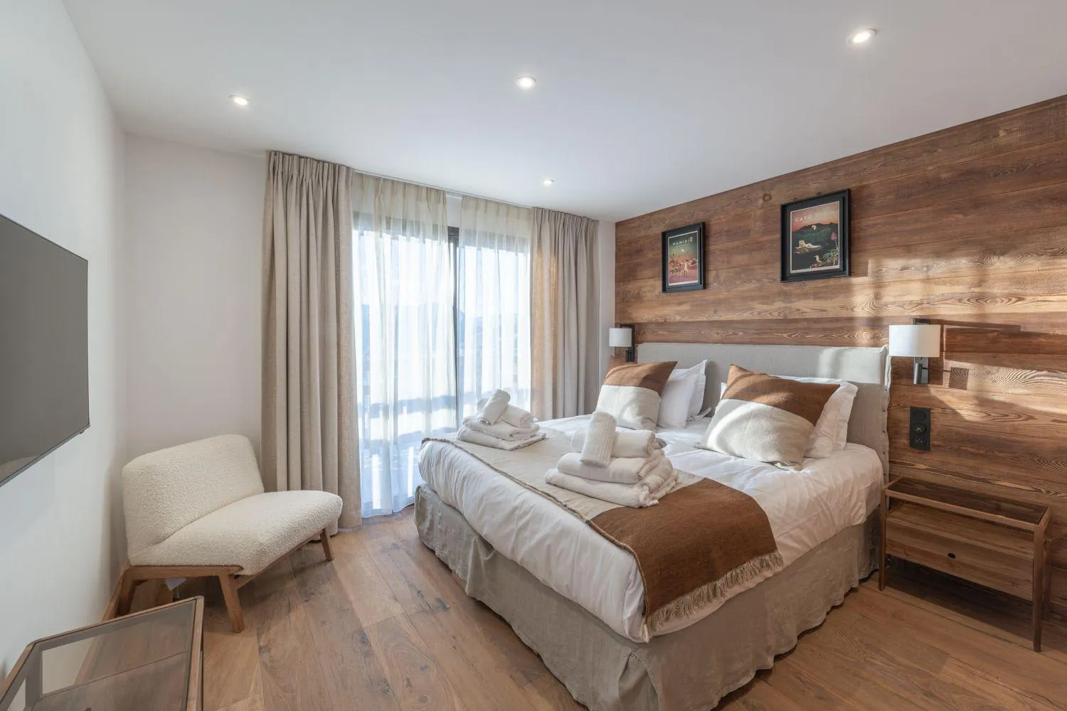 Double bedroom with a timber feature wall and balcony access
