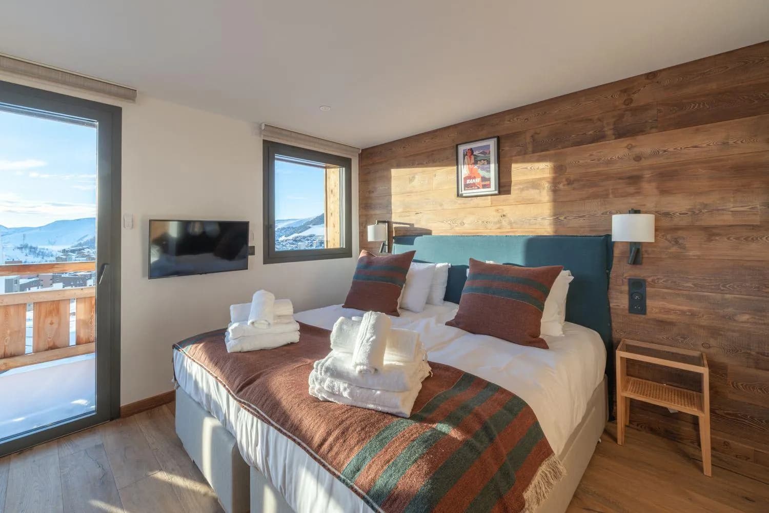 Master bedroom with balcony access and panoramic mountain views