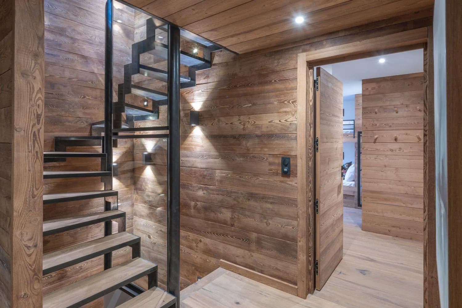 Timber staircase beside the children's bunk room