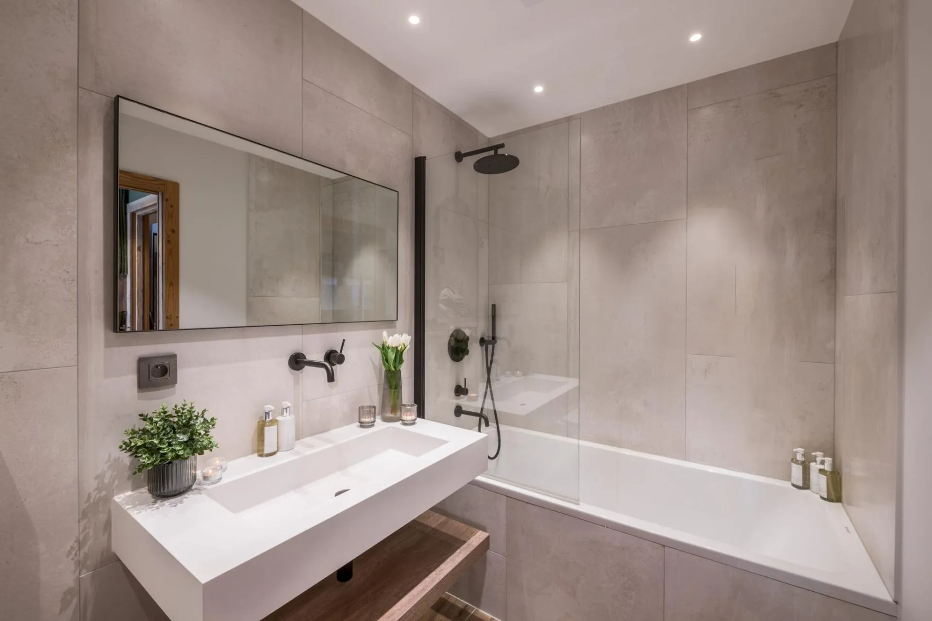 Bathroom with trough sink and bathtub with rainfall shower head