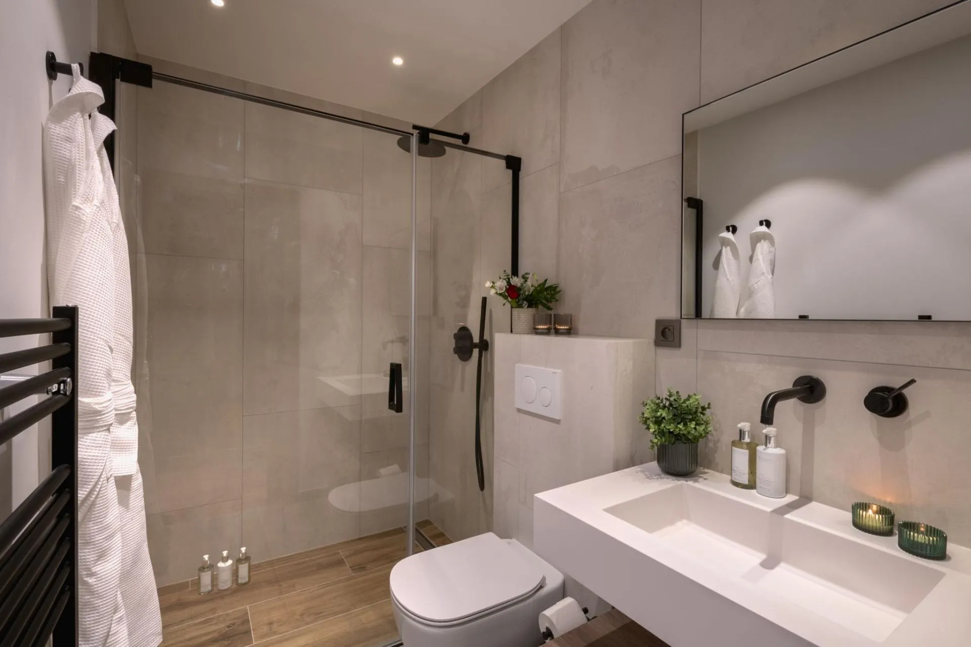 Bathroom with walk-in rainfall shower and heated towel rack