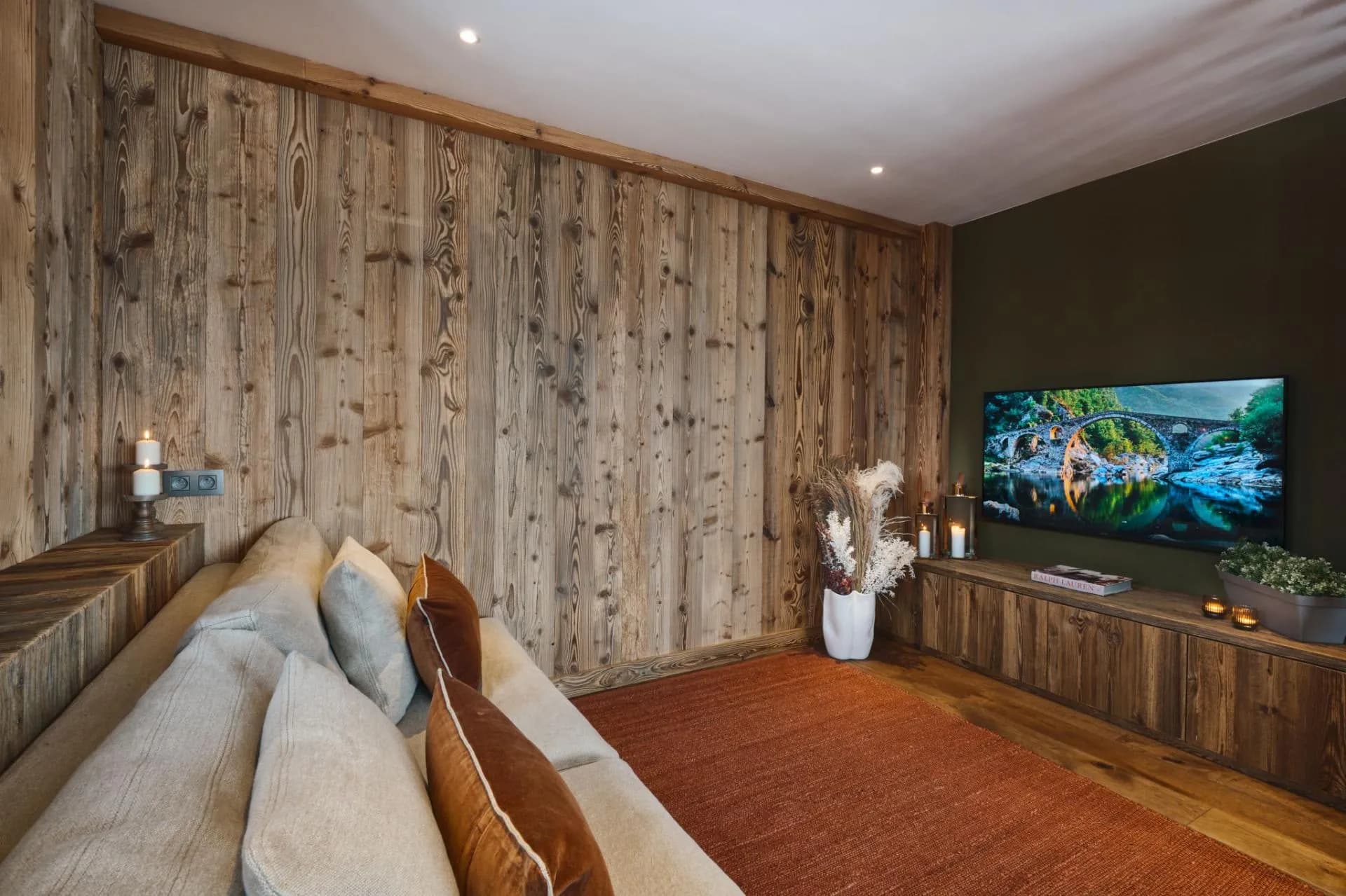 Home cinema with a large screen and timber-clad walls