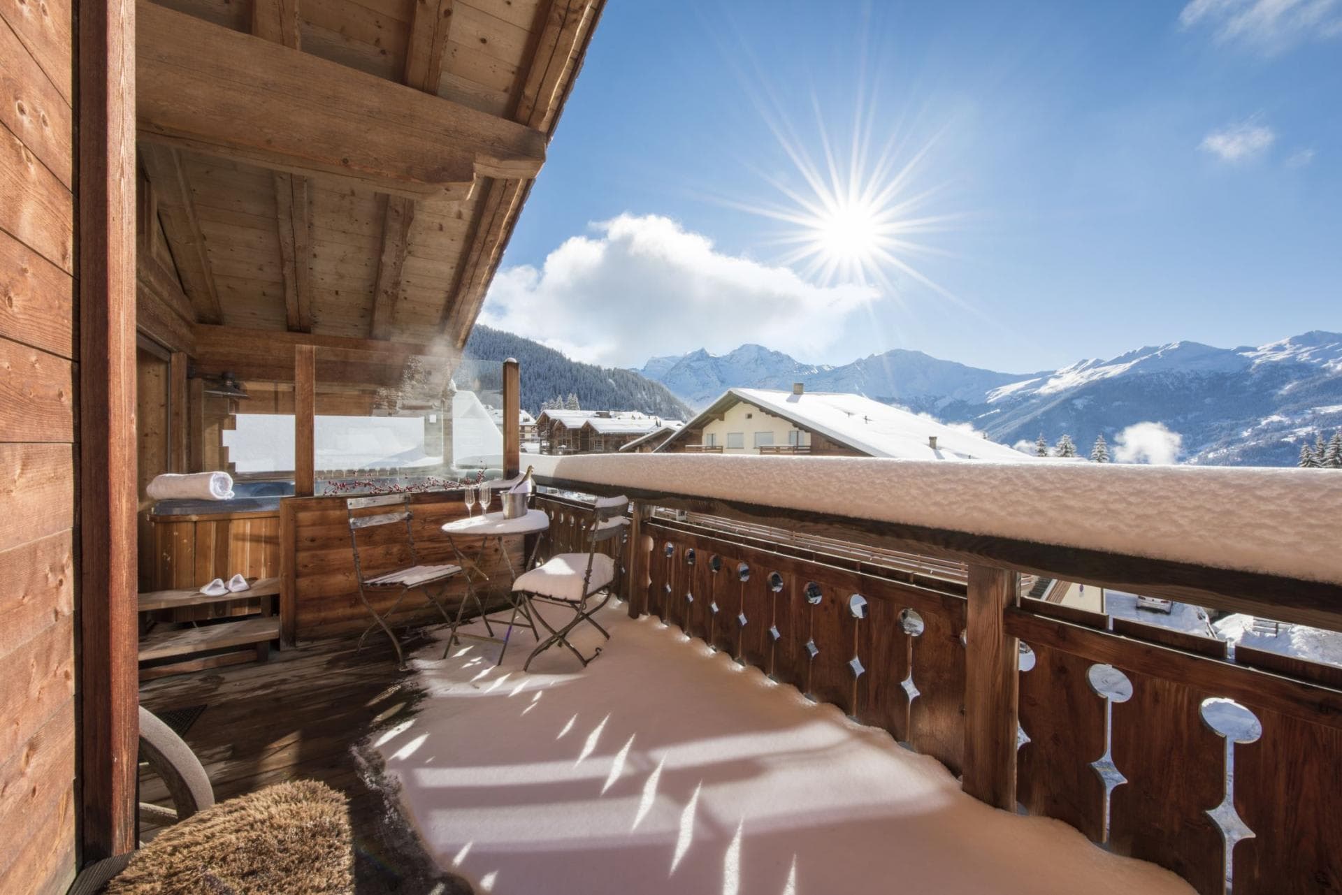 Covered balcony with private hot tub and mountain views