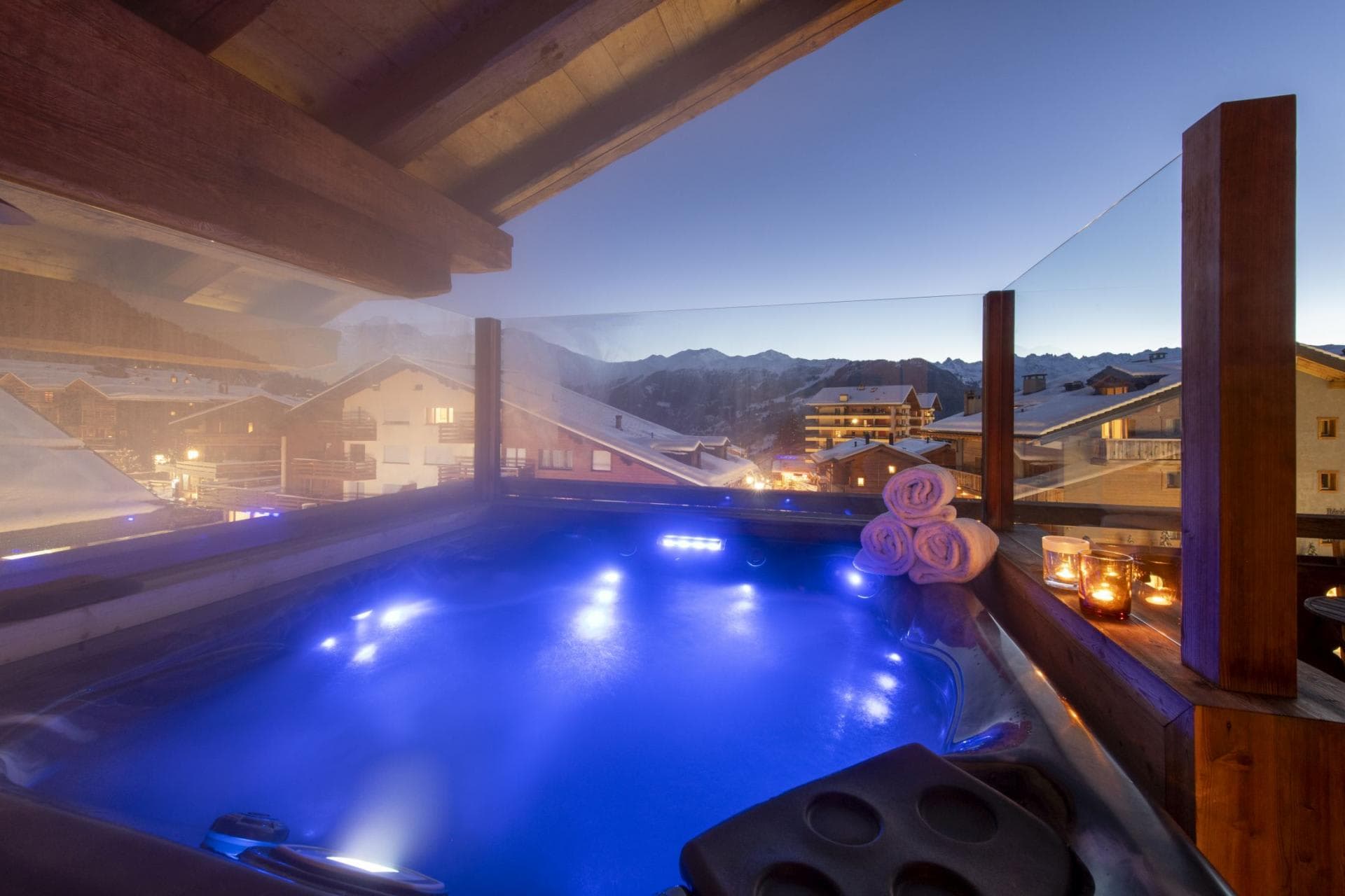 Private balcony hot tub with LED lighting and alpine valley views