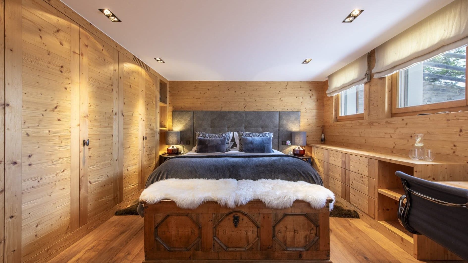 Bedroom with king bed, built-in wardrobes, and integrated desk area