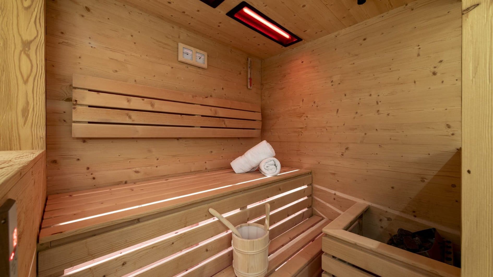 Private sauna with infrared heat lamp and traditional rock heater