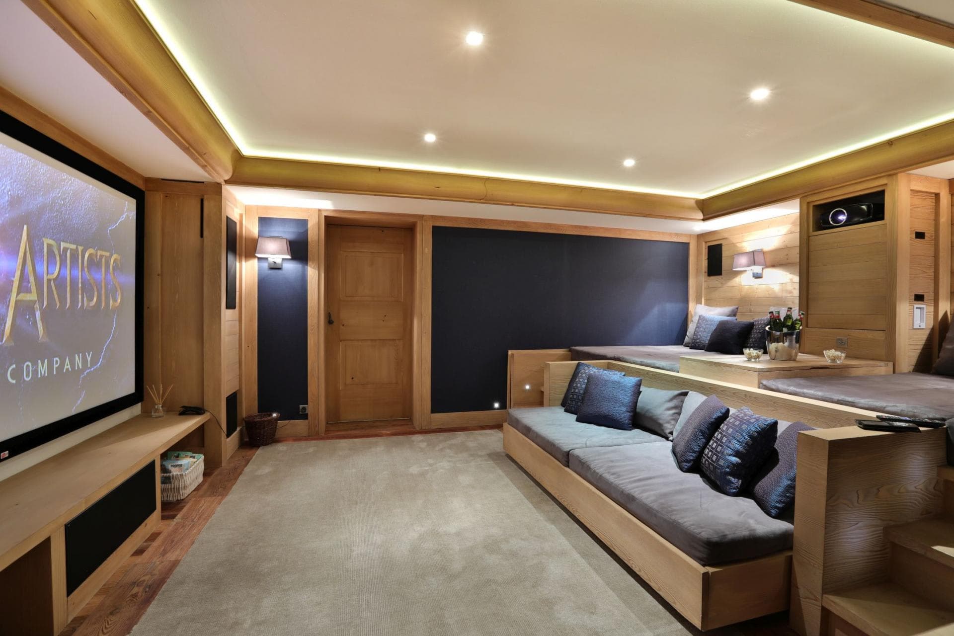 Media room with projector screen and tiered daybed seating