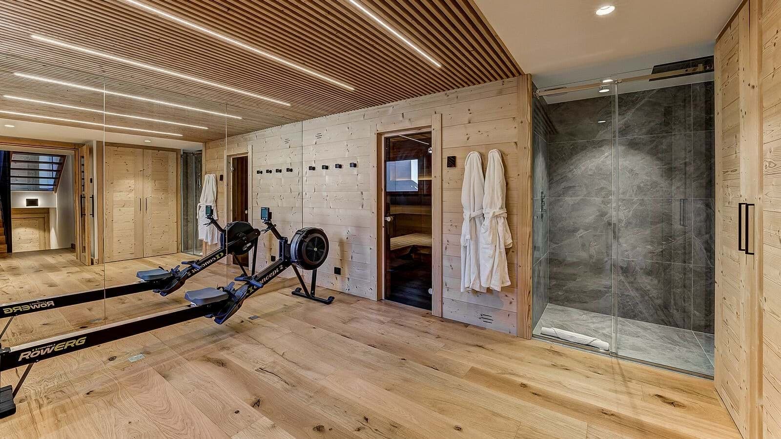 Fitness area with Concept2 rower, sauna, and walk-in rainfall shower