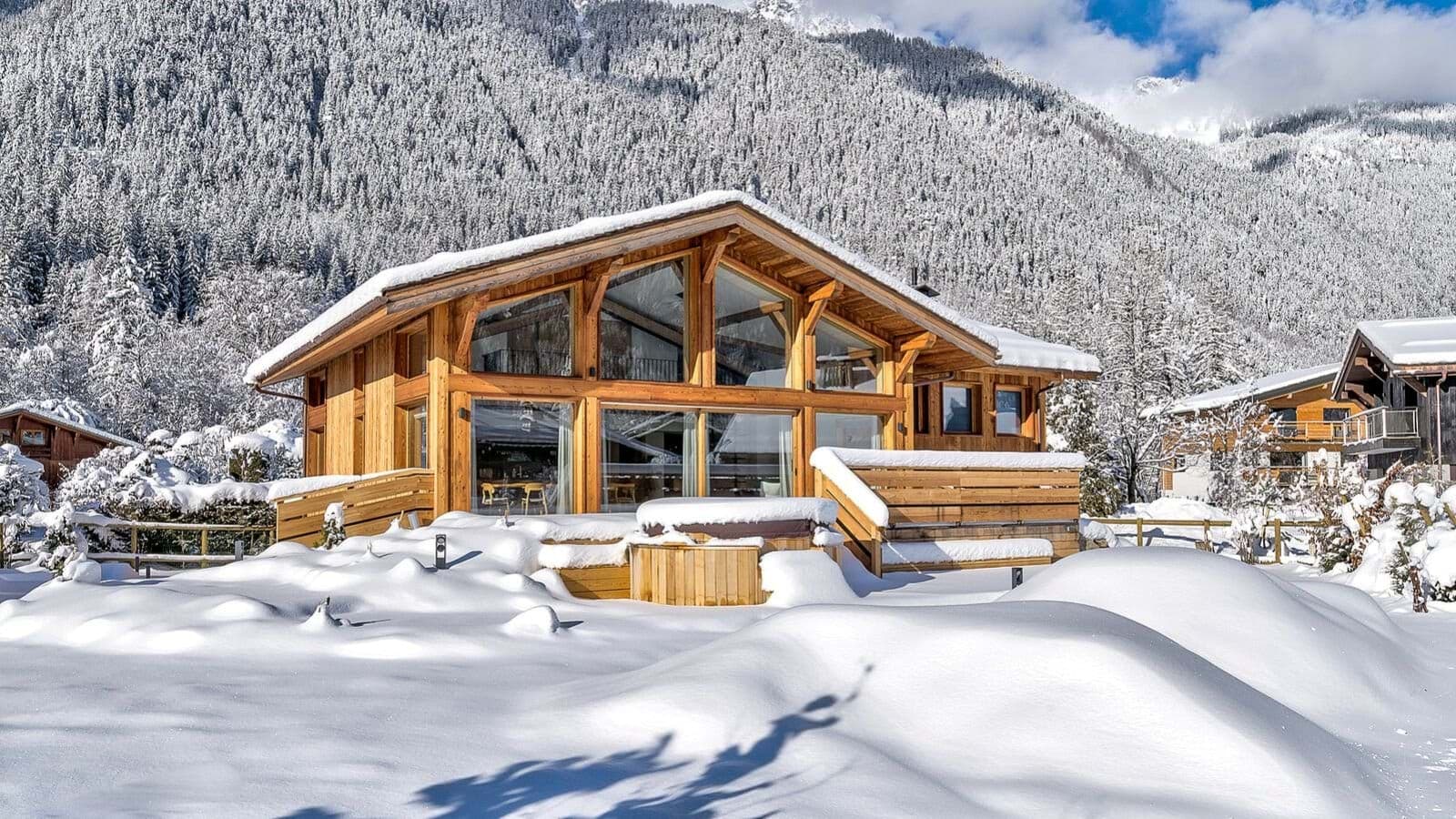 Chalet exterior with mountain views and outdoor hot tub