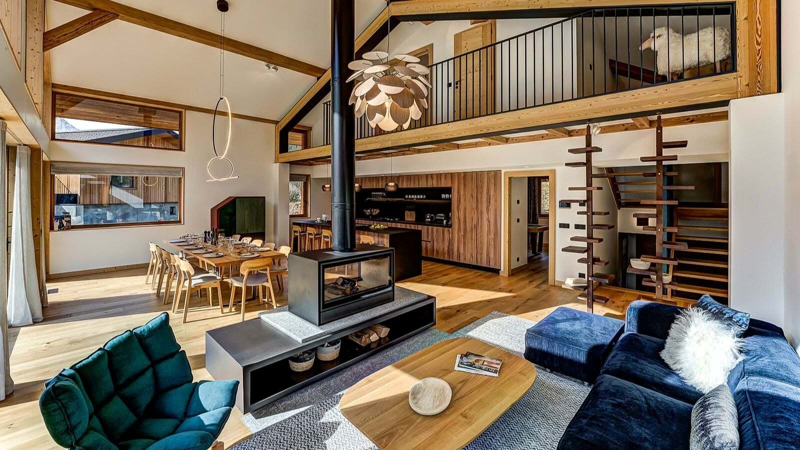 Open-plan living area with double-sided fireplace and dining seating for 10