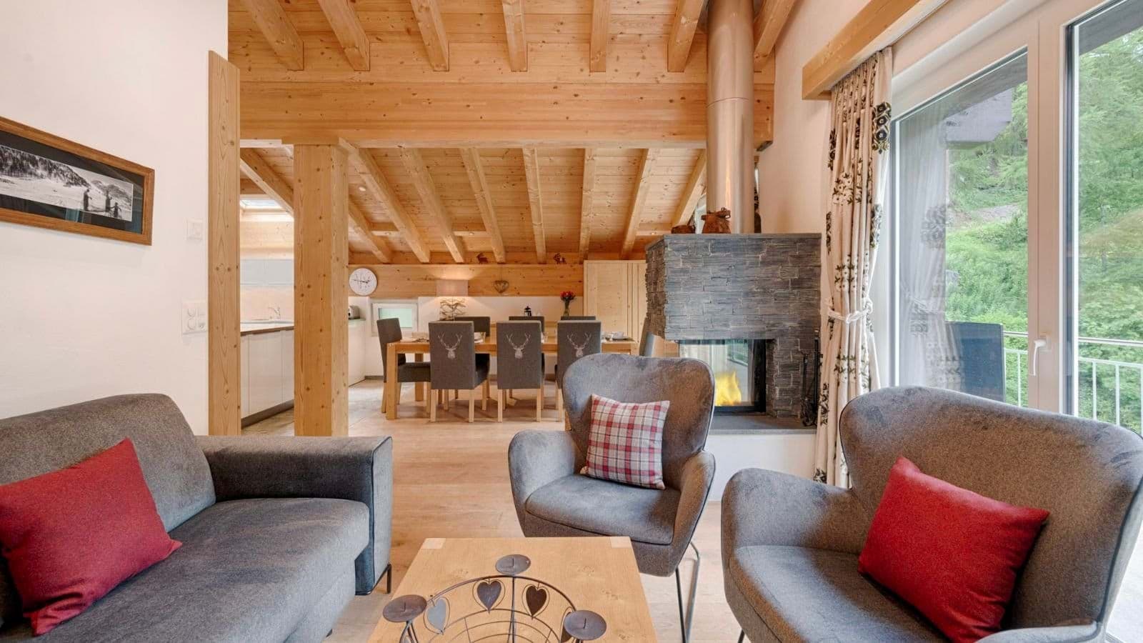 Open-plan living area with wood-burning fireplace and dining seating for 8