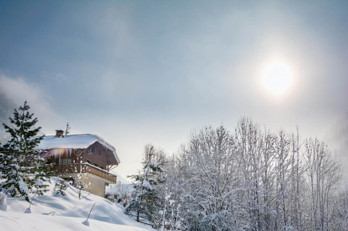 Chalet exterior with wrap-around balcony and mountain views
