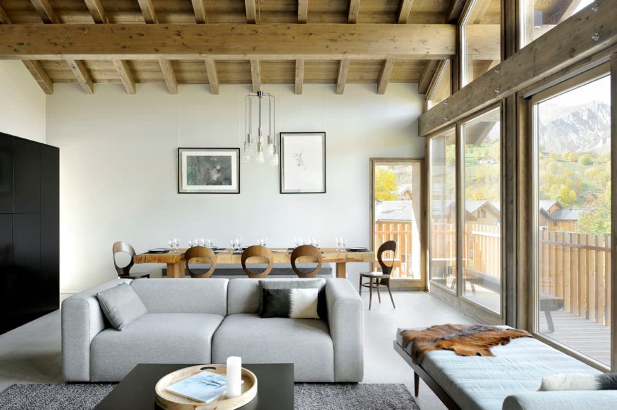Open-plan living area with vaulted timber ceilings and mountain views