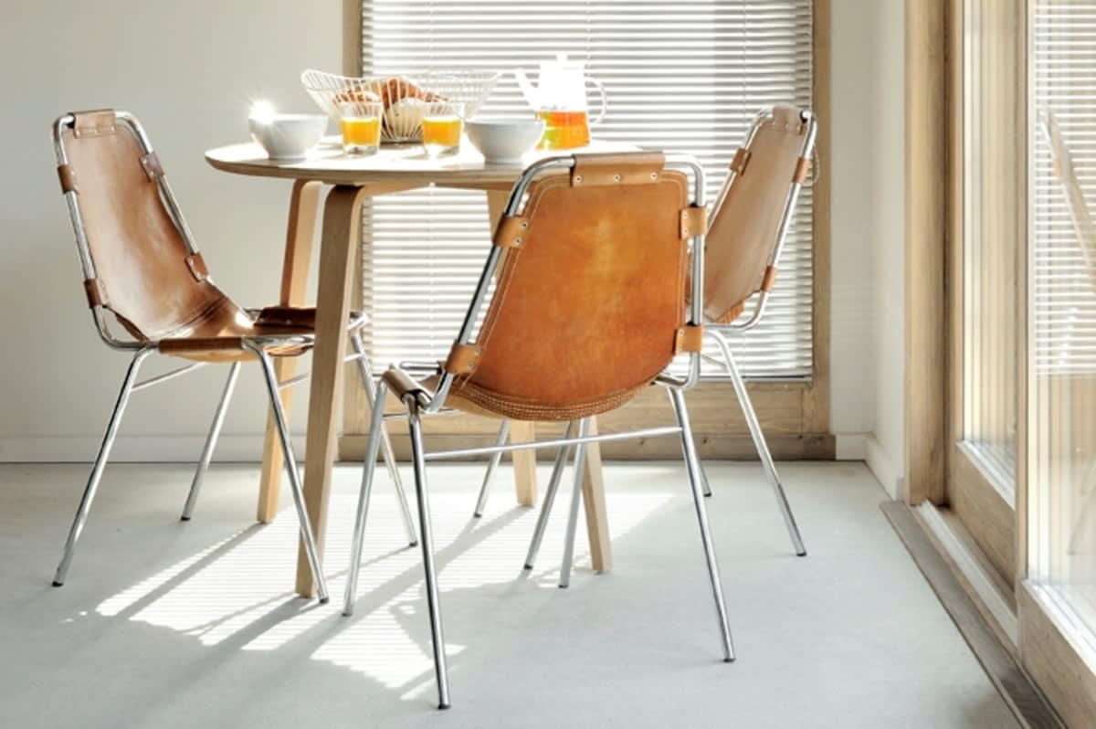 Breakfast nook with seating for 3 beside floor-to-ceiling windows