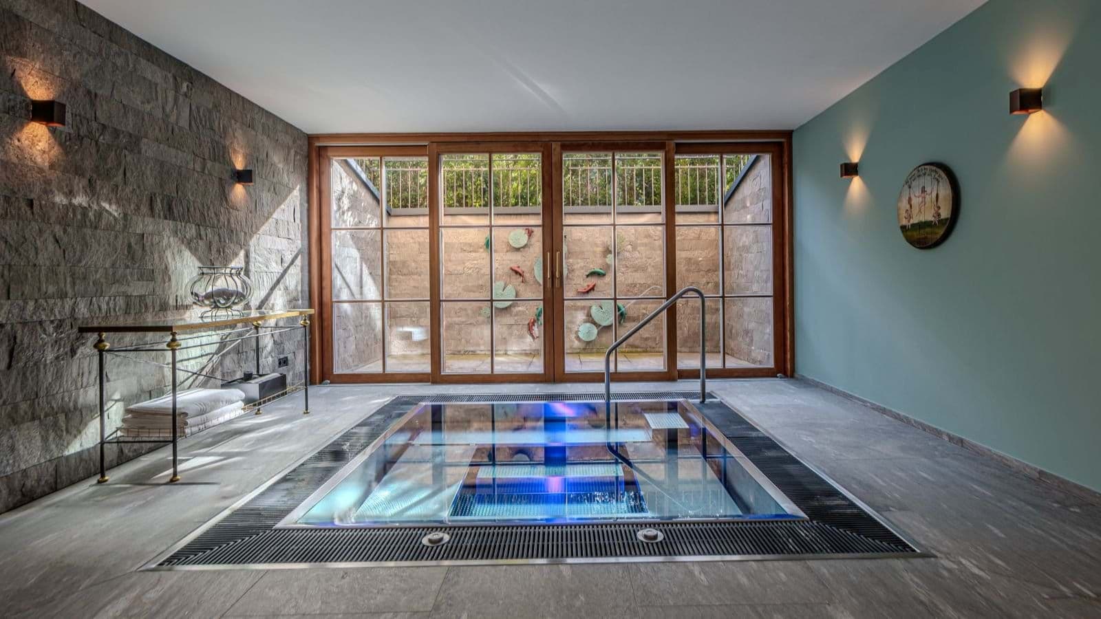 Indoor plunge pool with integrated handrail and private light-well courtyard