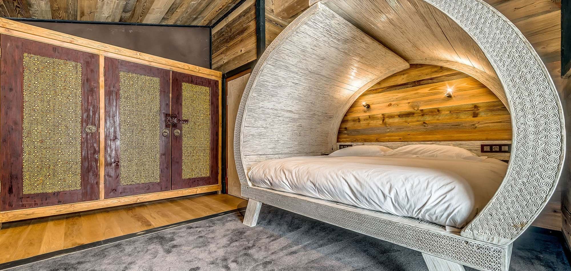 Unique barrel bed and carved wardrobe with built-in reading lights