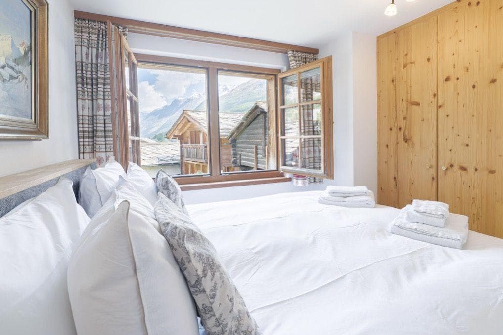 Bedroom with king bed, mountain views, and built-in closet