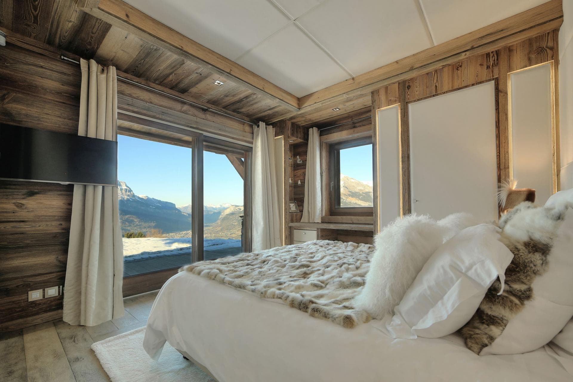 Bedroom with king bed and floor-to-ceiling mountain views