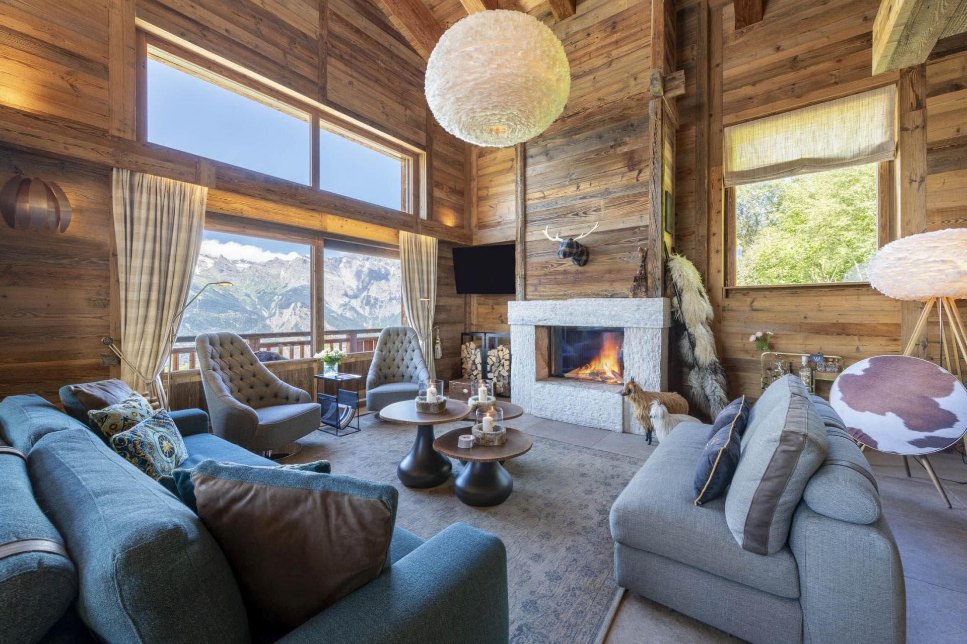 Living room with wood-burning fireplace and panoramic mountain views