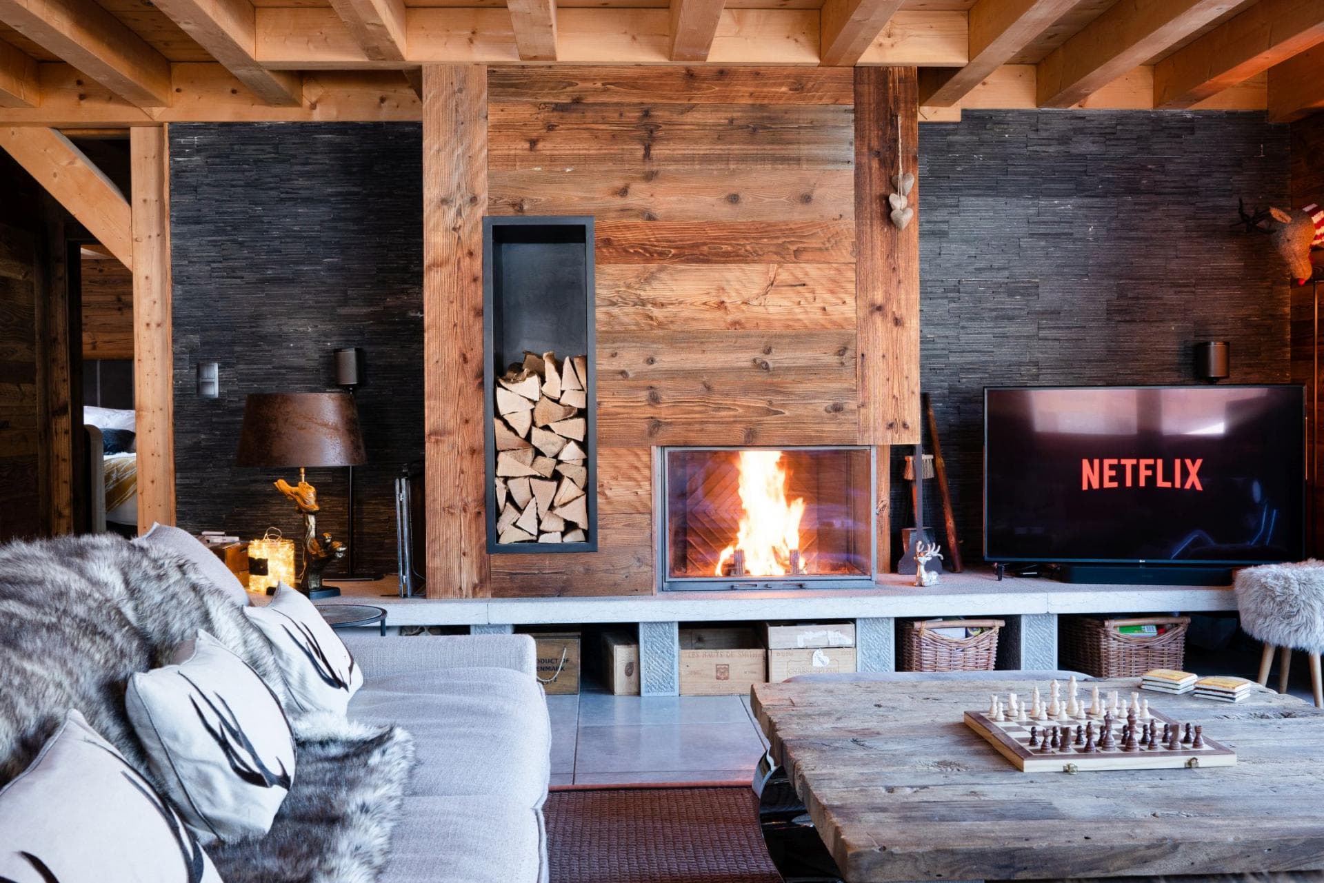Living area with wood-burning fireplace and smart TV with streaming apps