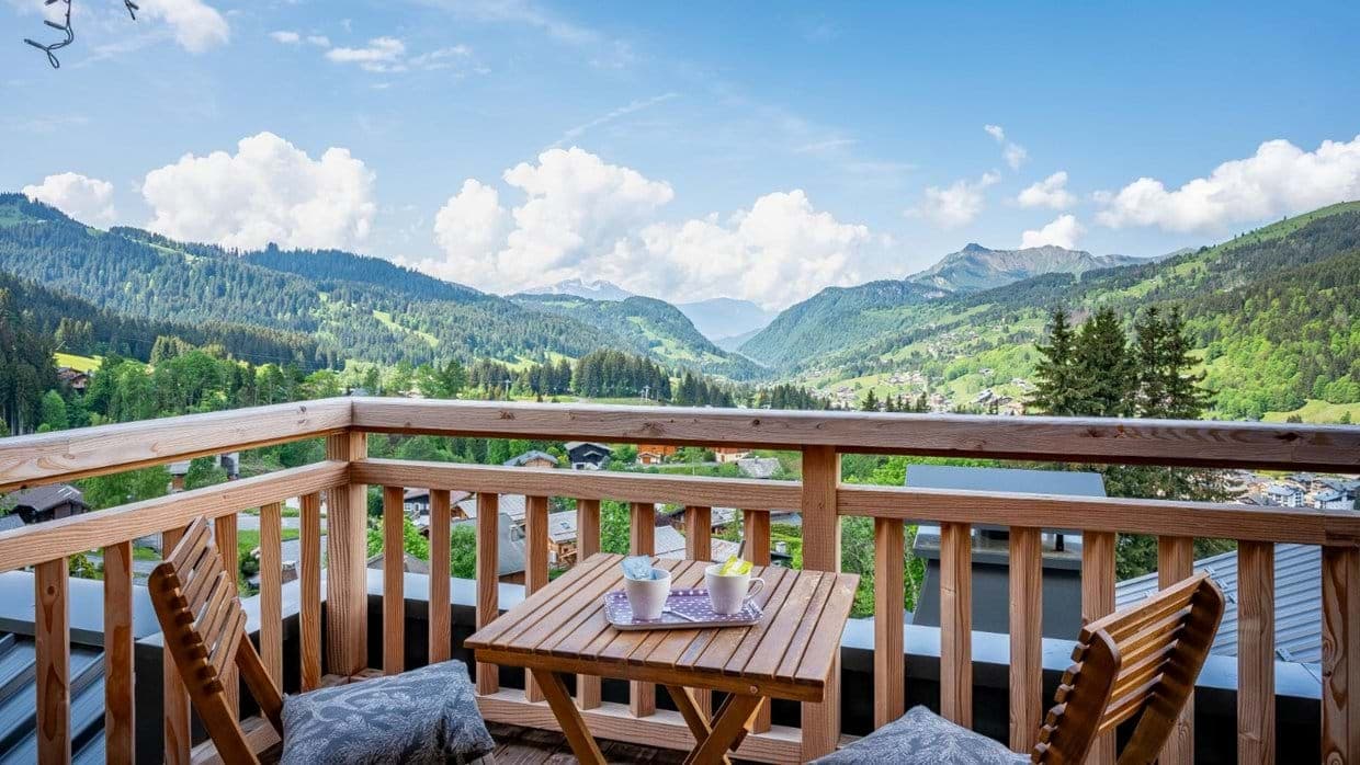 Balcony with bistro seating for two and mountain valley views