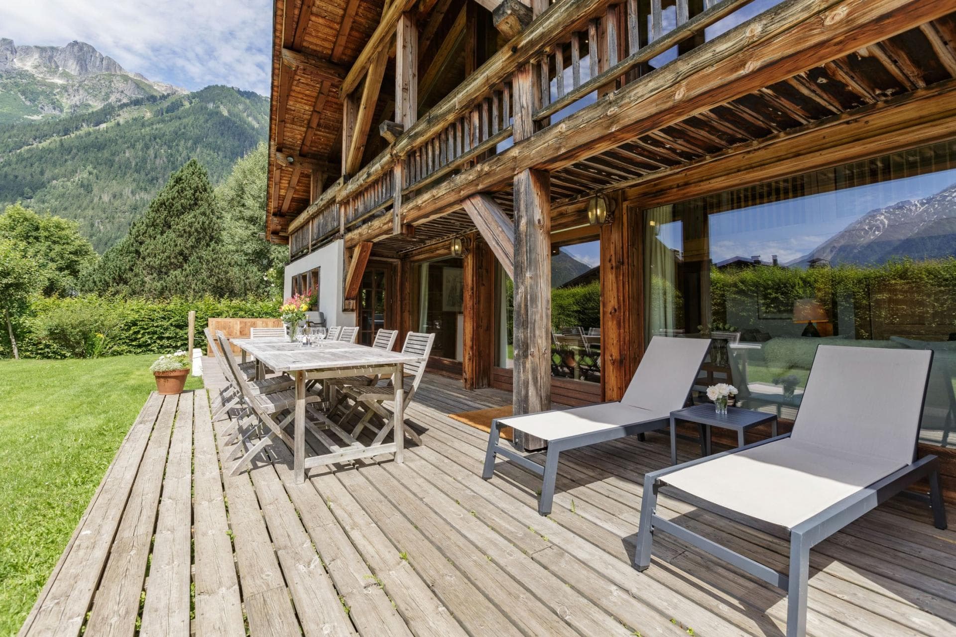 Ground floor terrace with 8-person dining table and mountain views