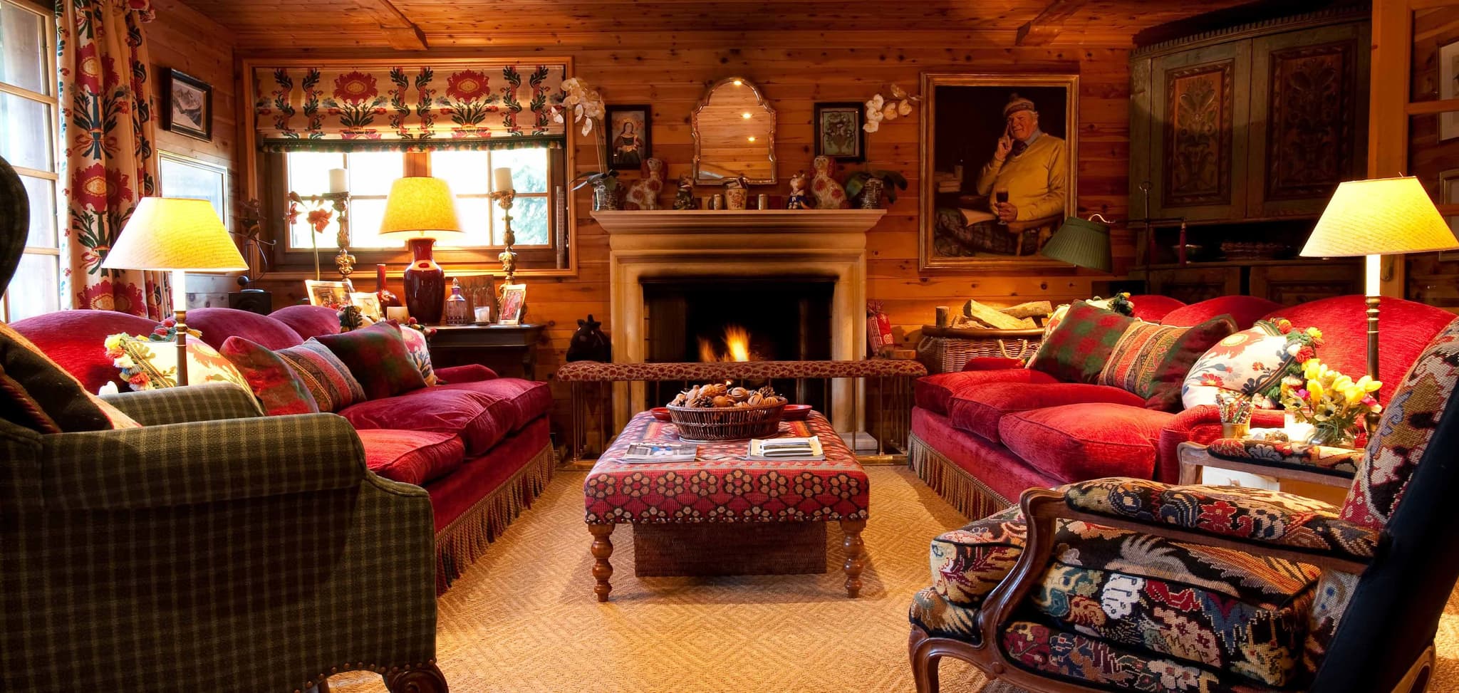 Log cabin living room with wood-burning fireplace and seating for 8