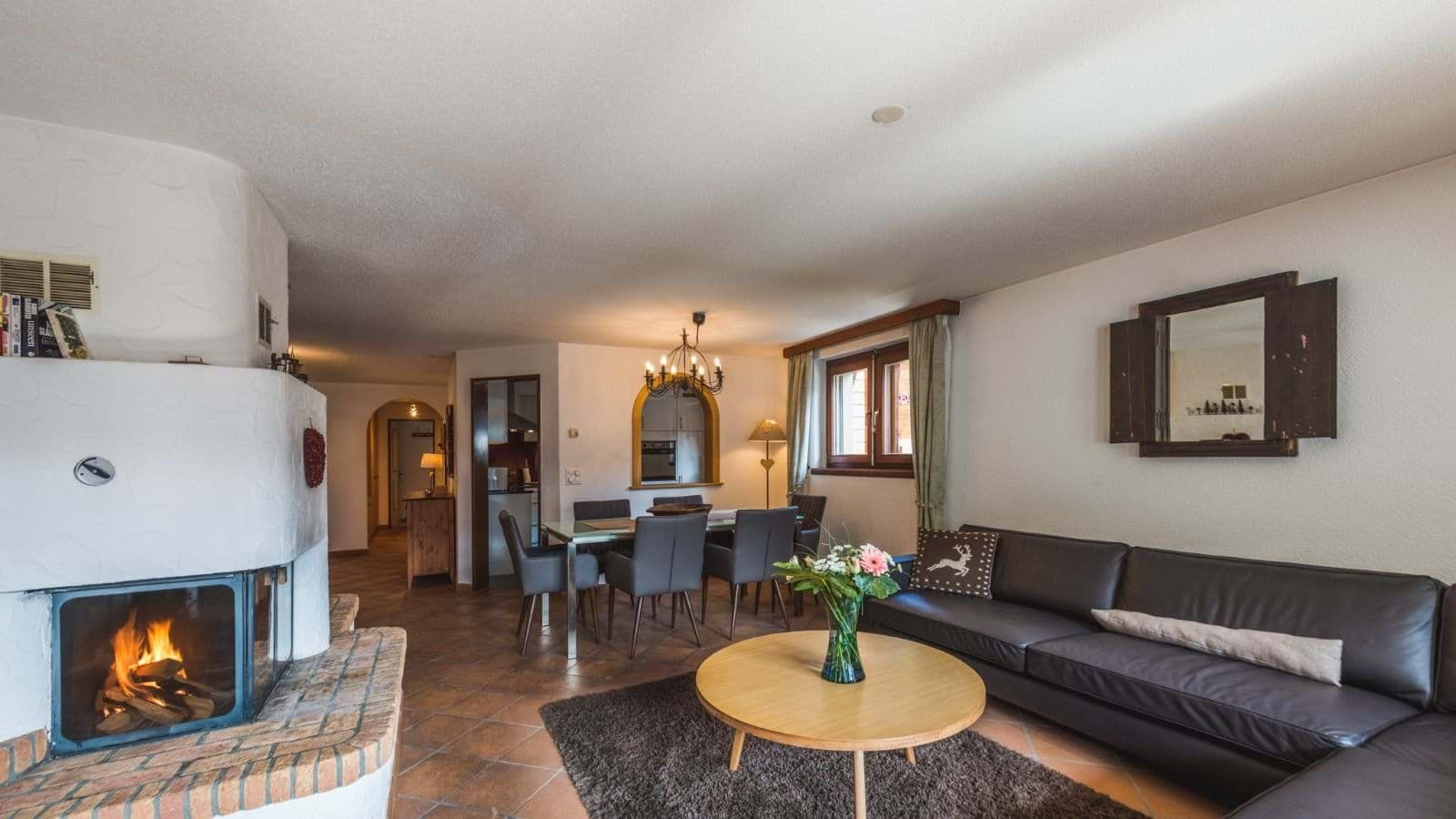 Open living area with wood-burning fireplace and dining seating for 6