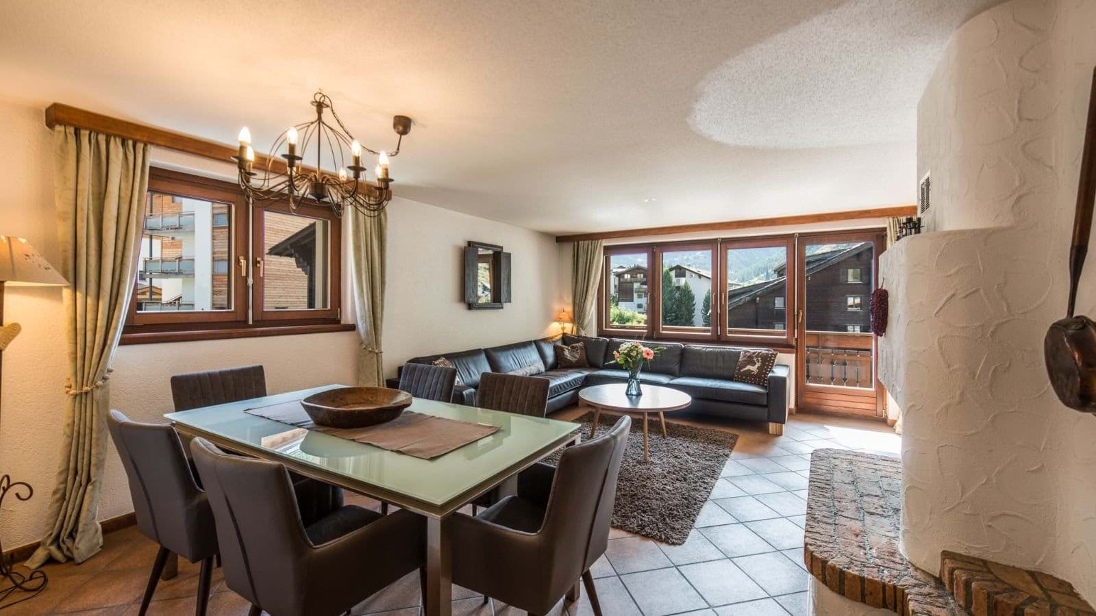 Open living area with wood-burning fireplace and balcony access