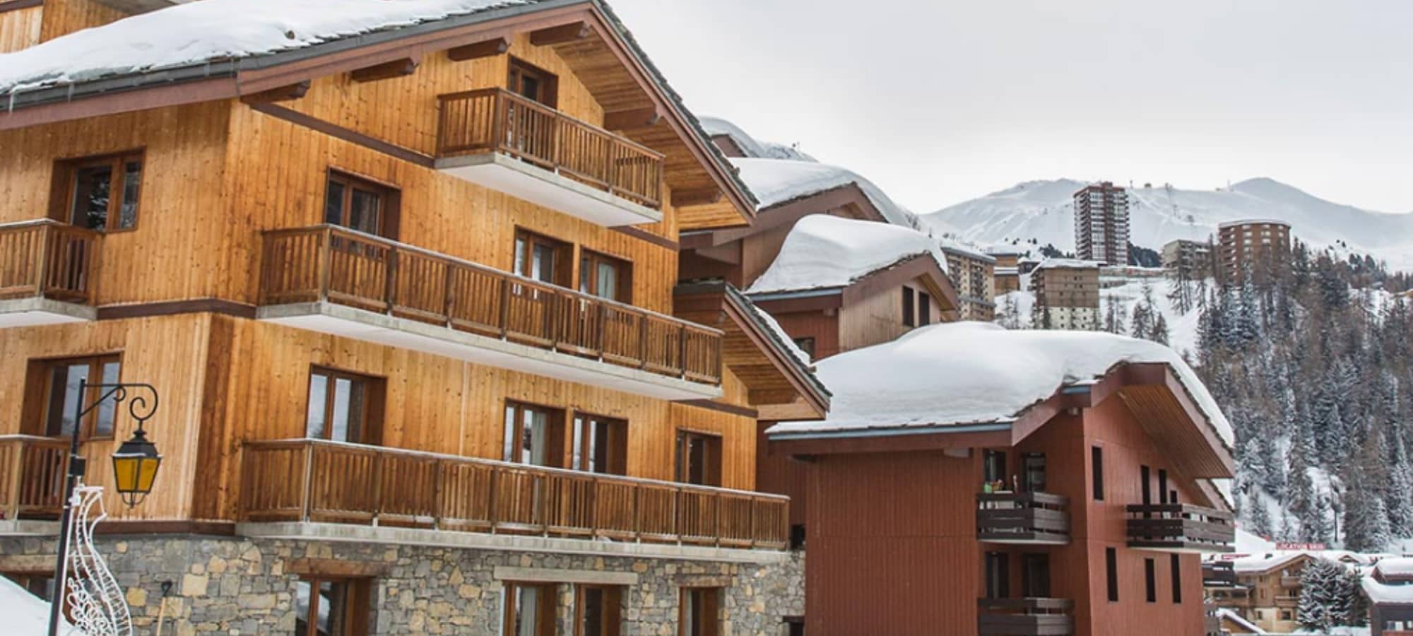 Ski-in ski-out chalet exterior with private balconies and mountain views