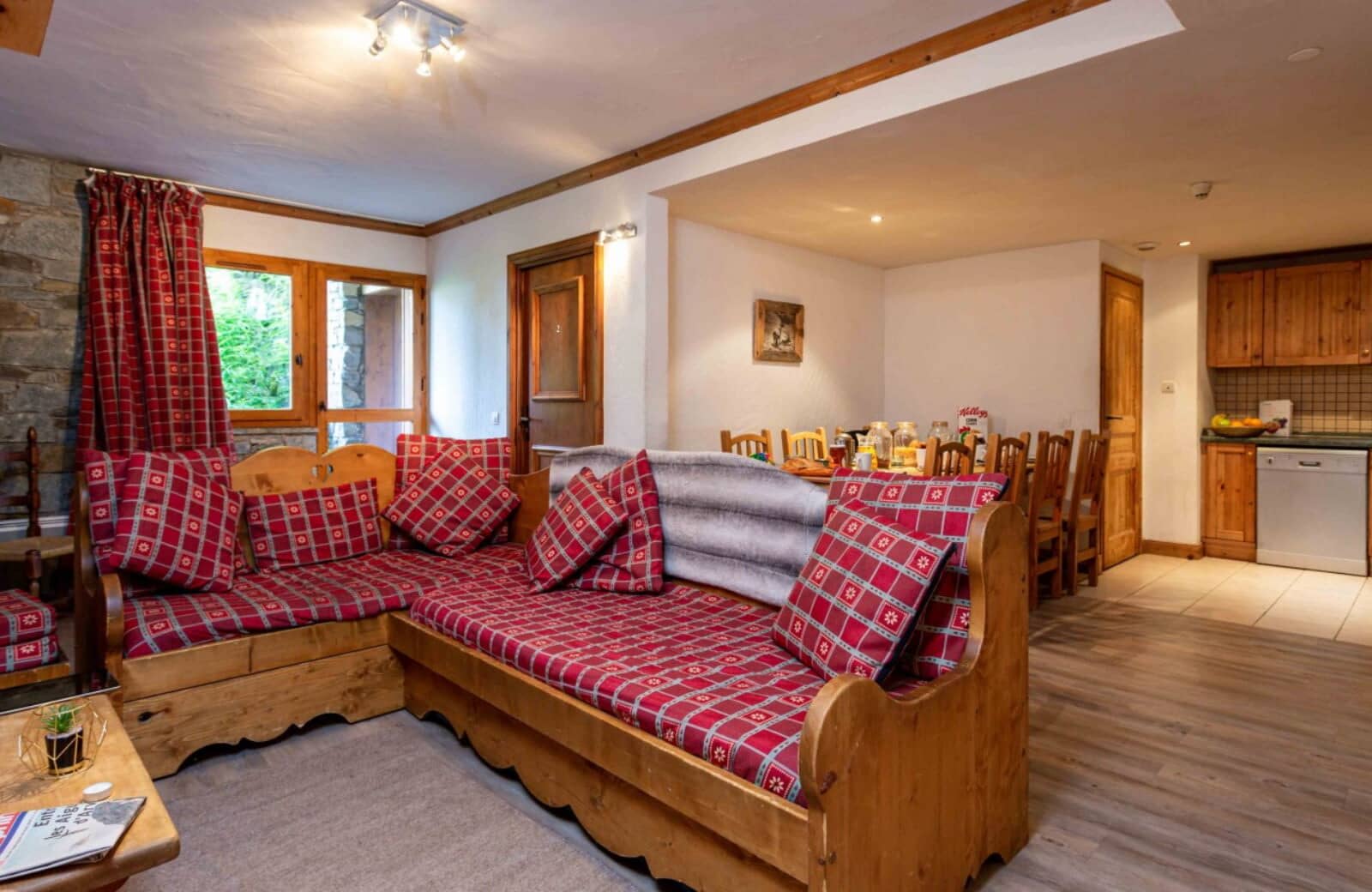 Open living area with daybed seating, dining table, and kitchenette