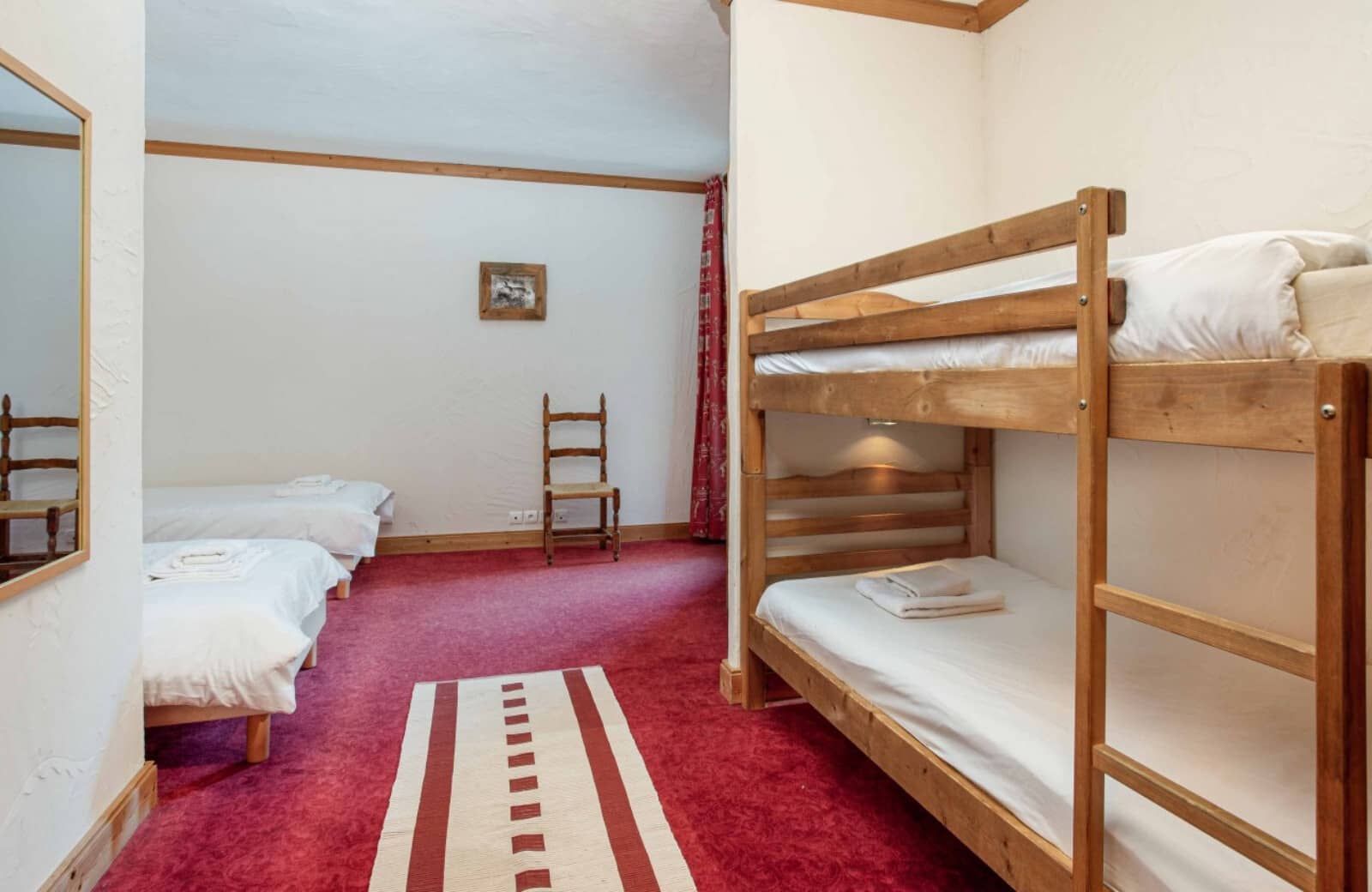Guest bedroom with twin bunk beds and two additional twin beds