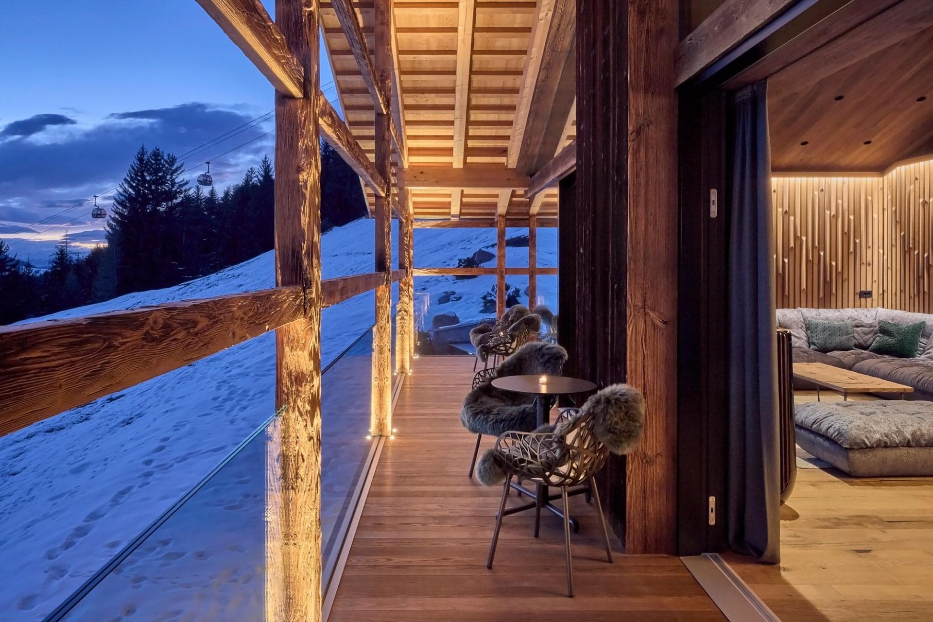 Covered balcony with fur-lined seating; views of the ski run and gondola