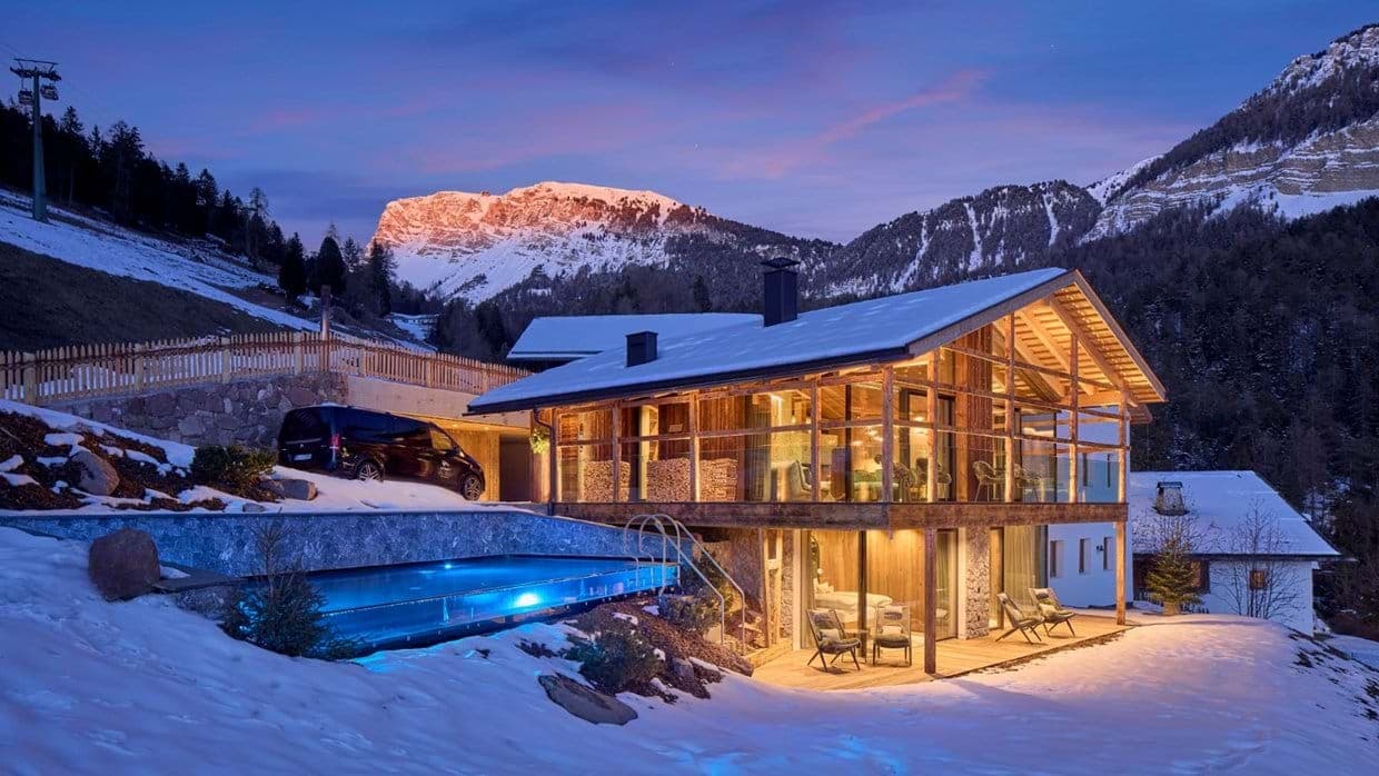 Mountain chalet with glass-walled infinity pool and Alpine views