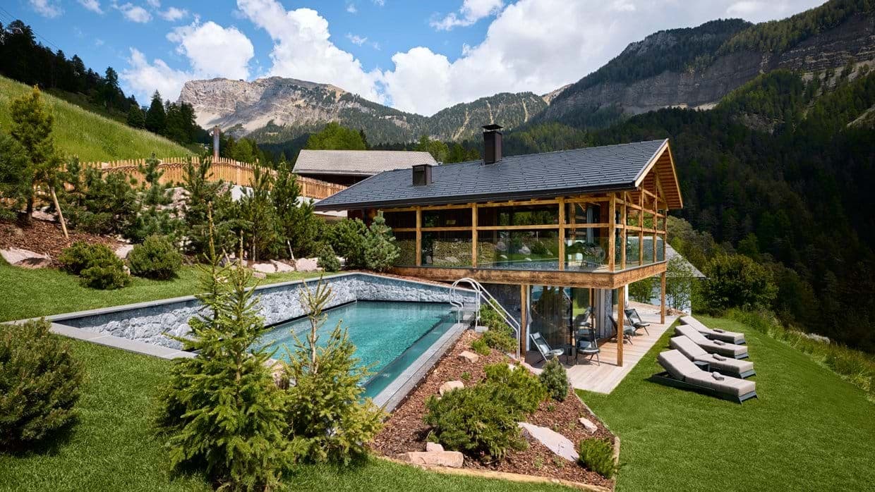 Outdoor pool and sun loungers with mountain views
