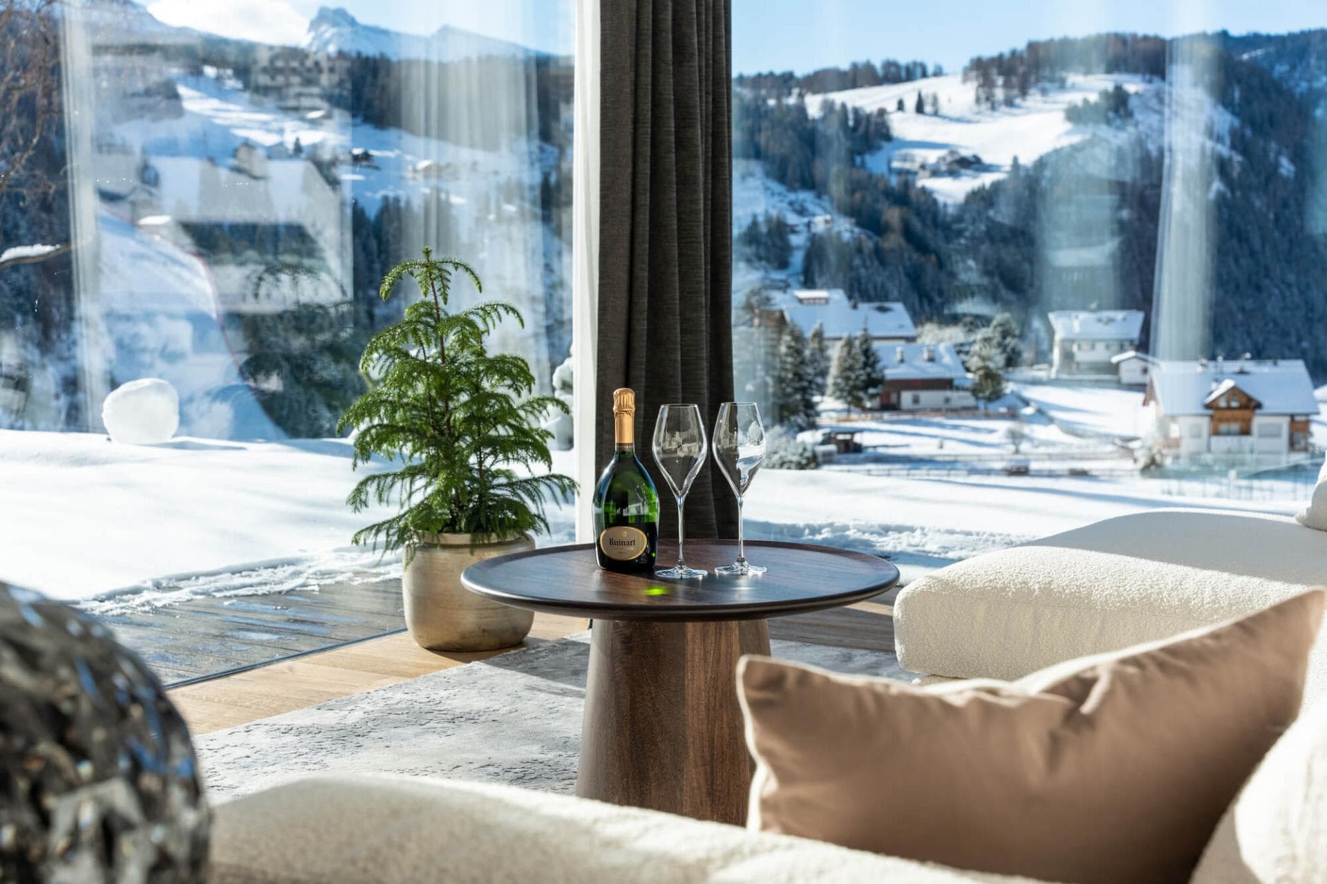 Floor-to-ceiling windows with panoramic alpine valley views and terrace access