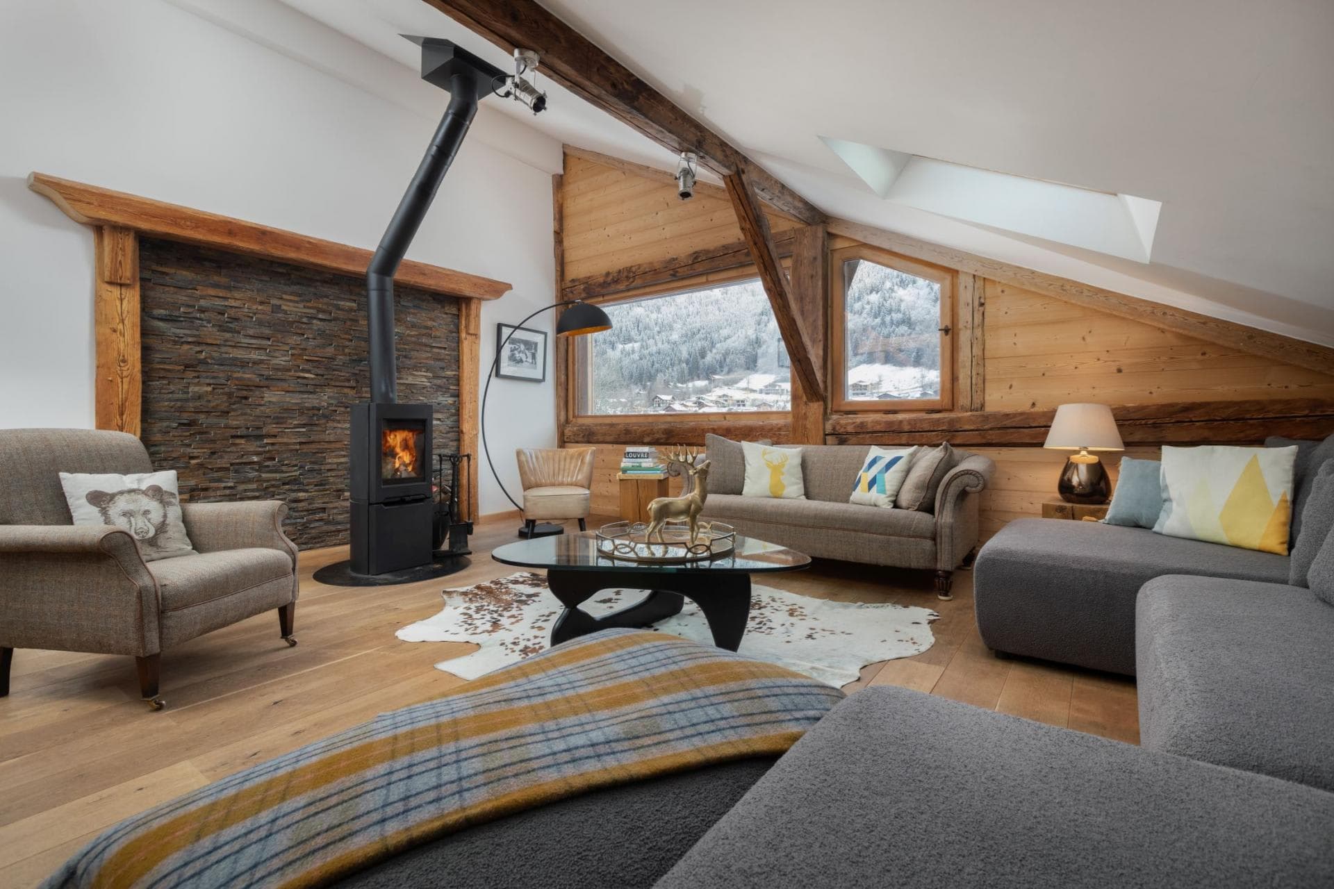 Top floor living area with wood-burning stove and mountain views
