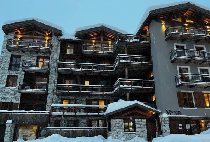 Ski-in/ski-out lodge exterior with private balconies and stone facade