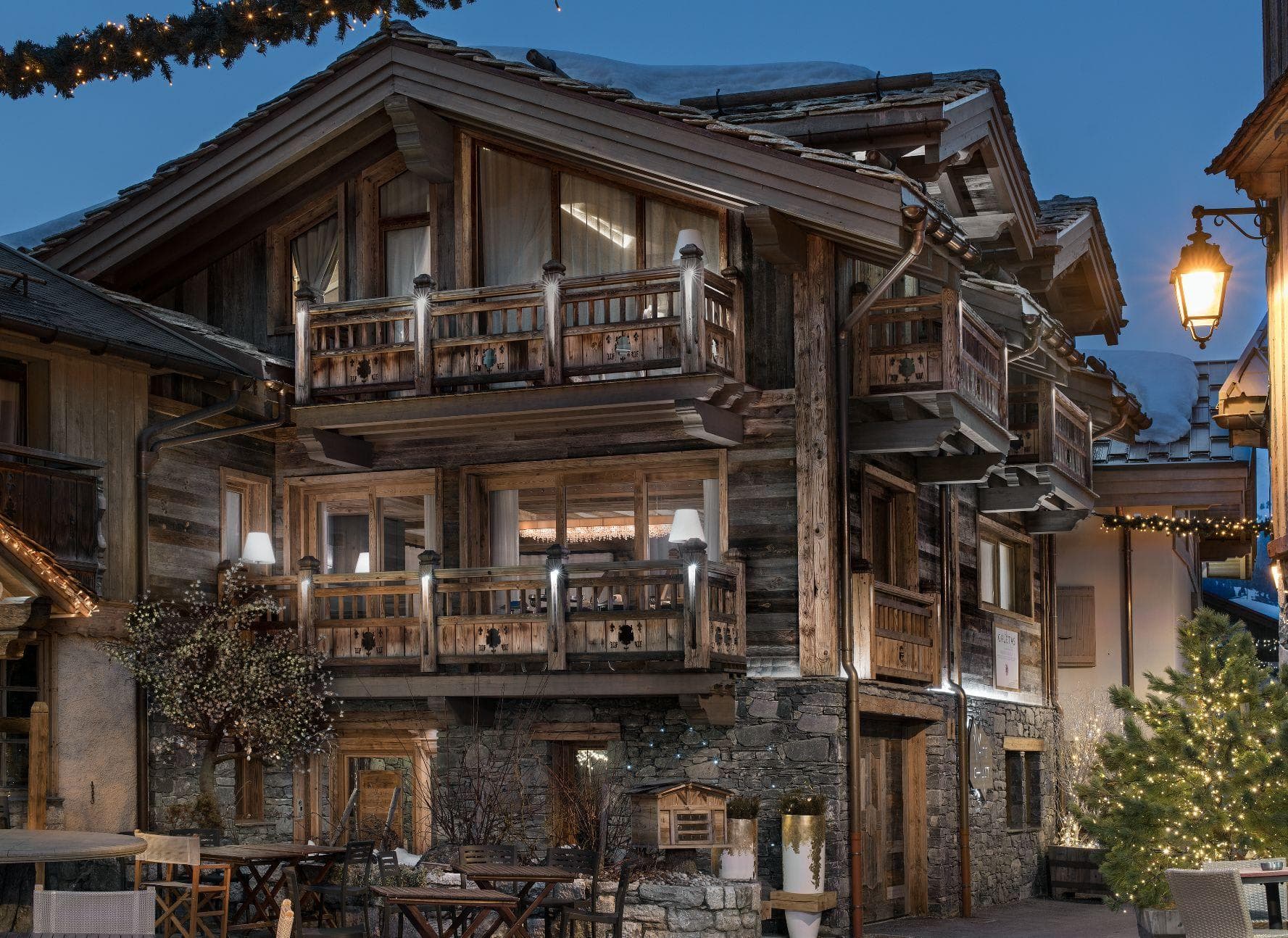 Stone and timber chalet exterior with multiple private balconies