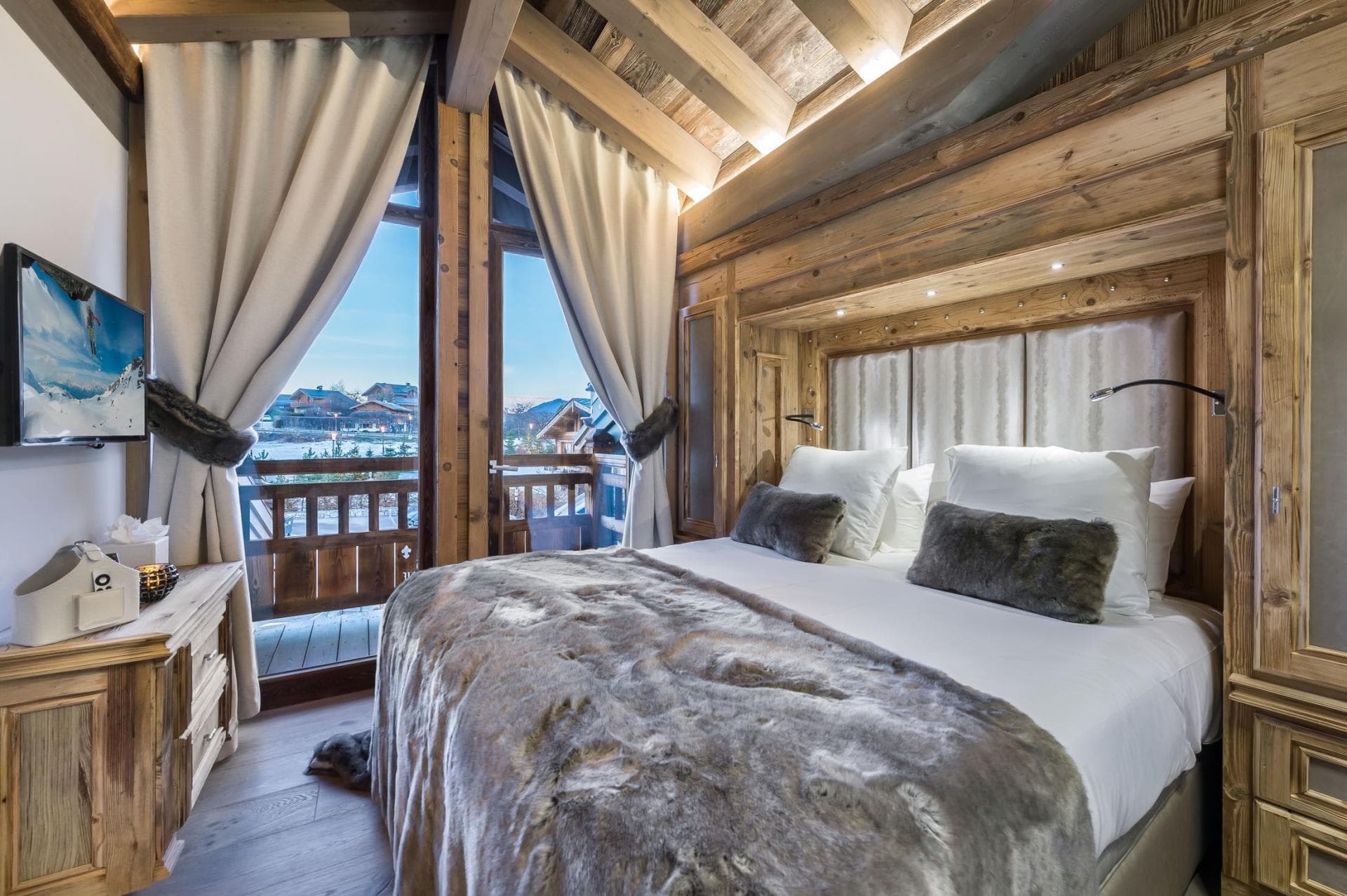 Bedroom with king bed and private balcony access to mountain views