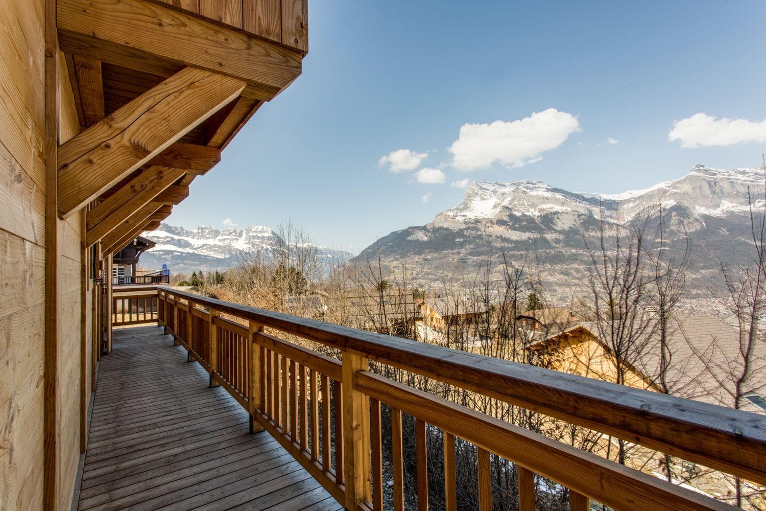 Wraparound deck with mountain views; snow-capped peaks visible across valley