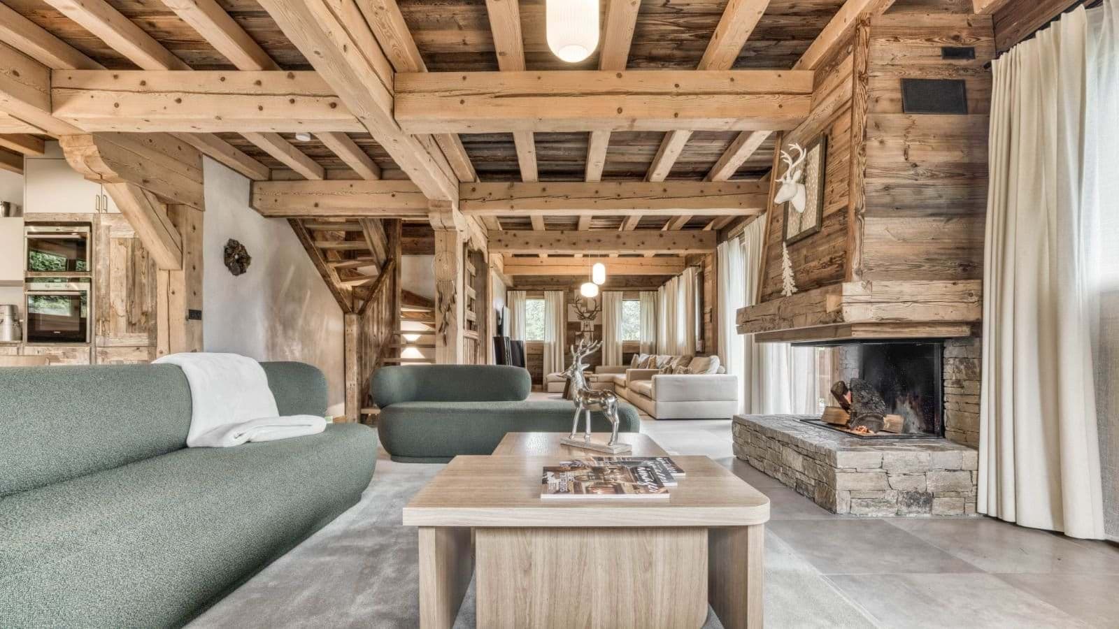 Living room with wood-burning fireplace and exposed timber beams
