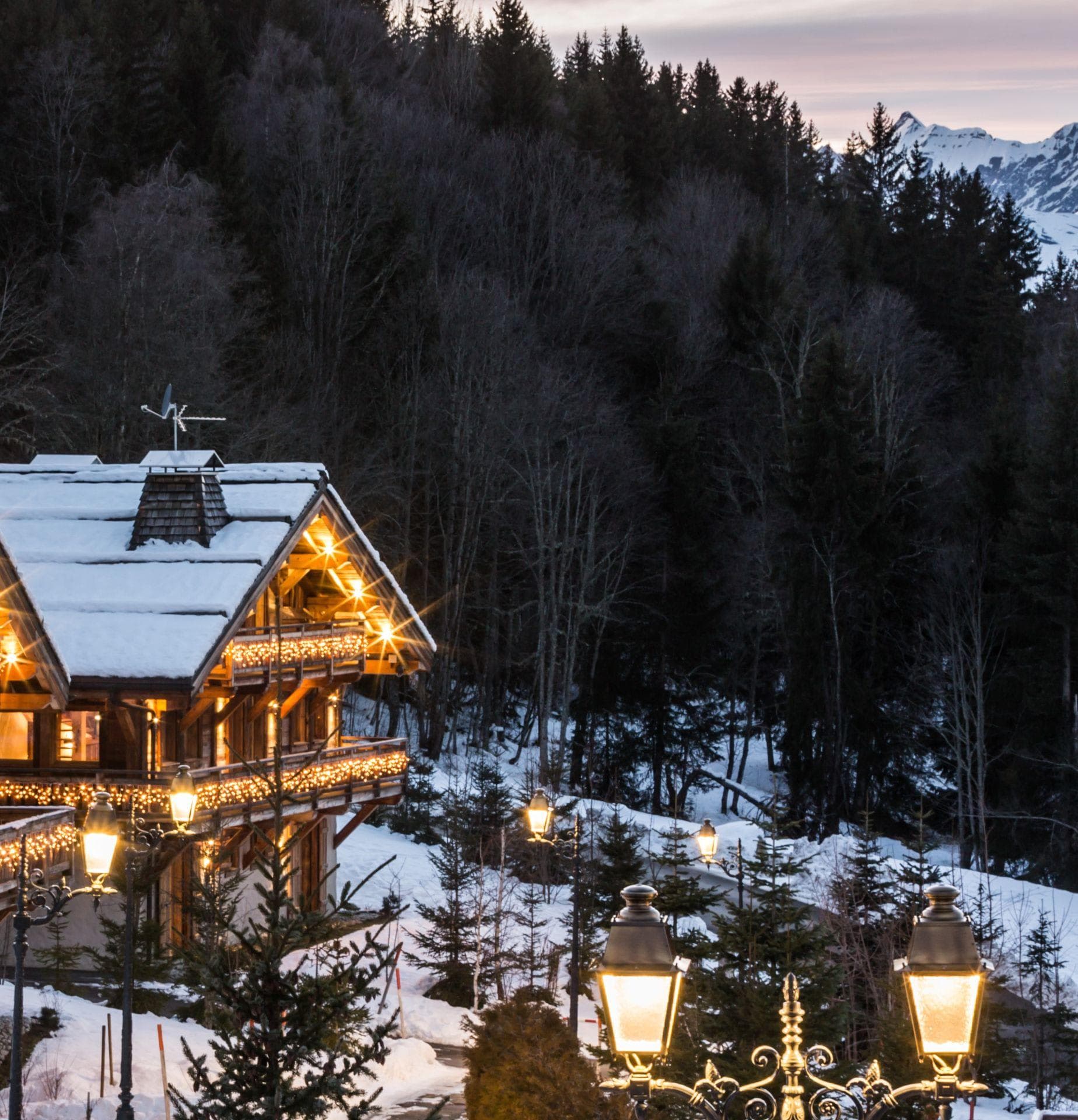 Chalet exterior with multi-level balconies and mountain peak views